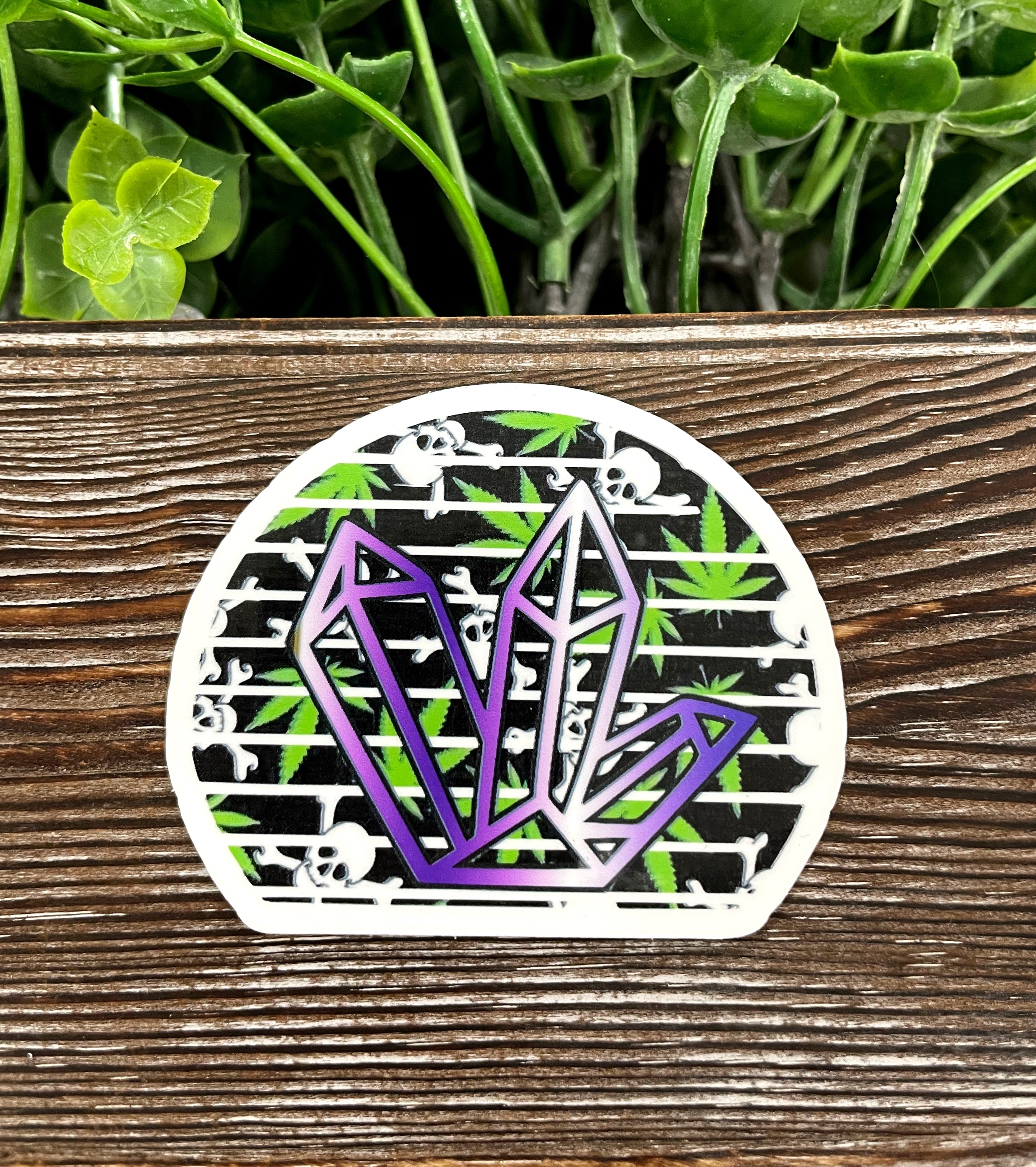 Purple crystal die cut sticker on a smooth surface, showcasing vibrant colors and intricate design.