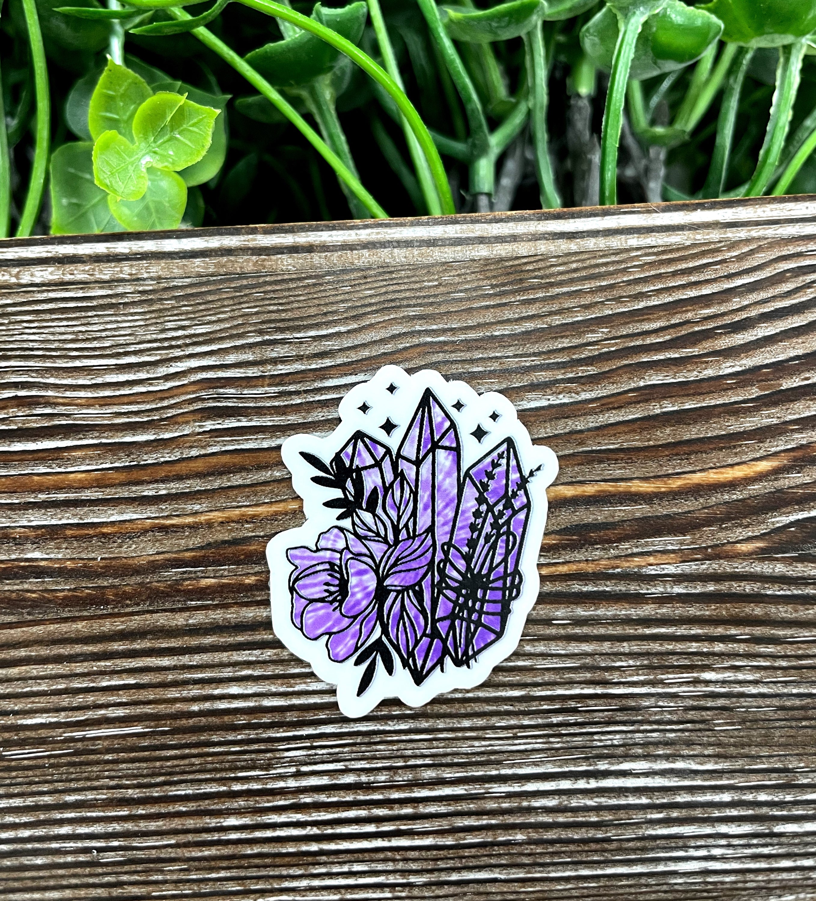Purple tie dye boho crystal die cut sticker on a smooth surface, showcasing vibrant colors and intricate design.