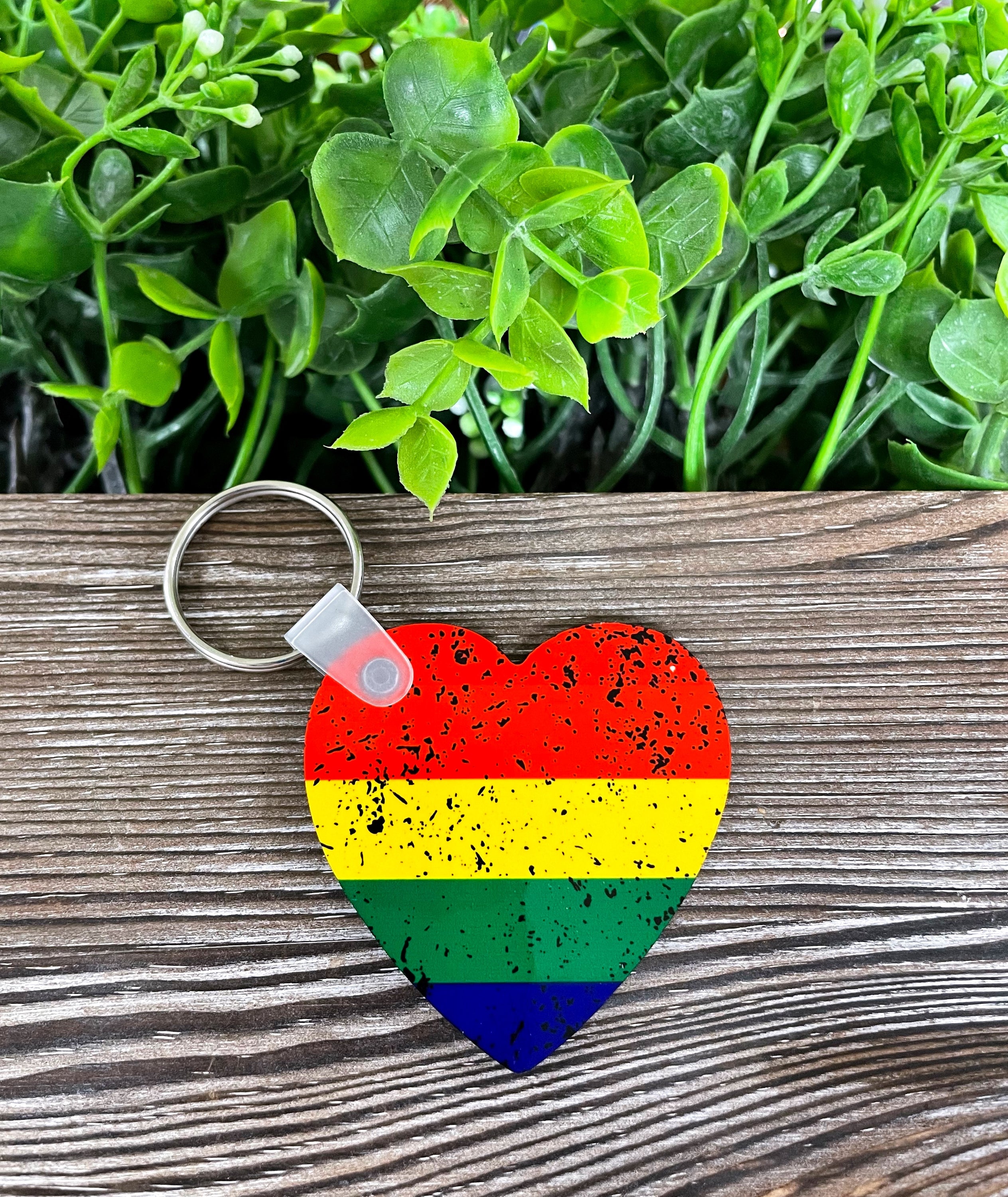 A colorful Rainbow Heart MDF keychain, symbolizing love and equality, featuring a vibrant design on a lightweight wooden base.