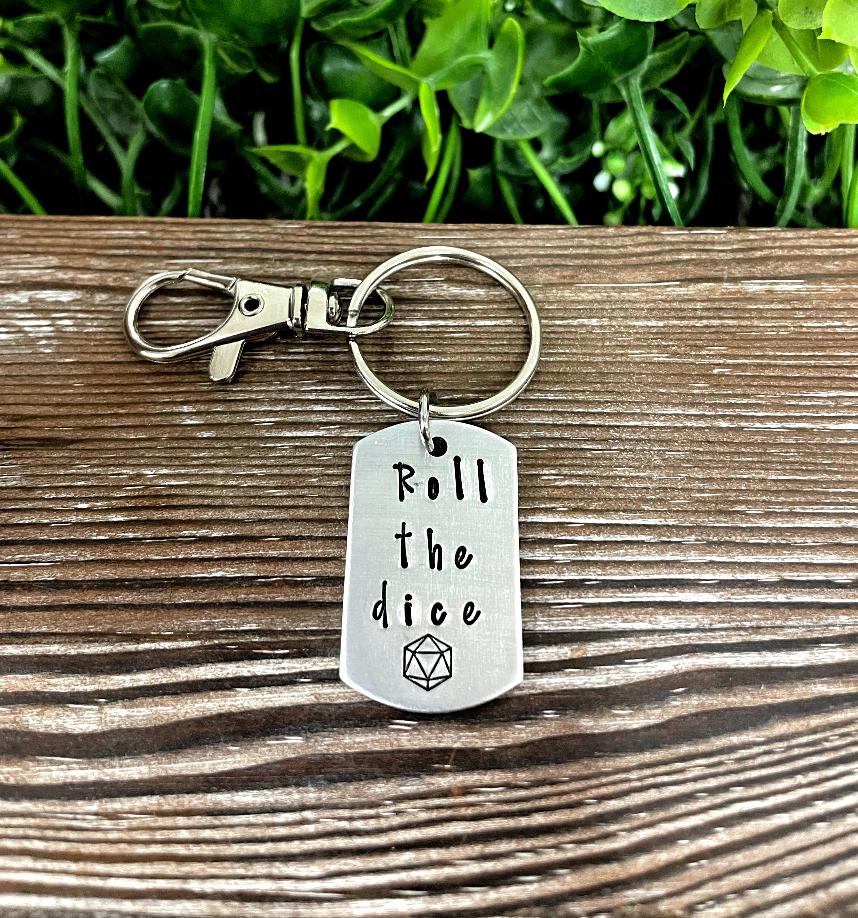 Hand-stamped key chain featuring a gamer dice theme with the phrase 'Roll the Dice', showcasing unique variations.