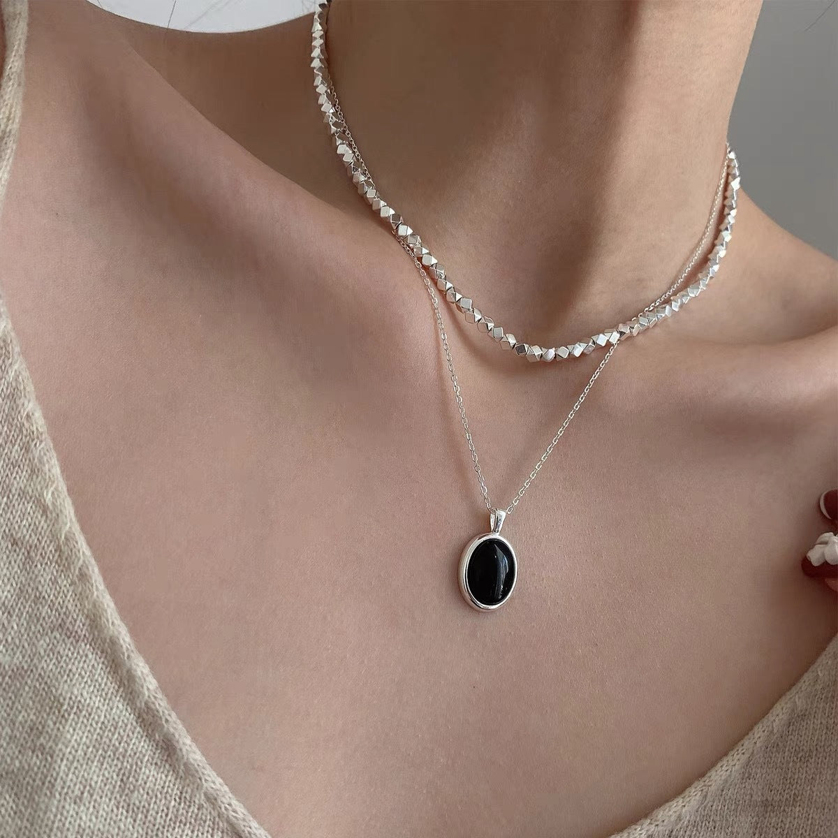 A beautiful s925 sterling silver necklace featuring a black onyx pendant, showcasing elegance and style for women's summer fashion.