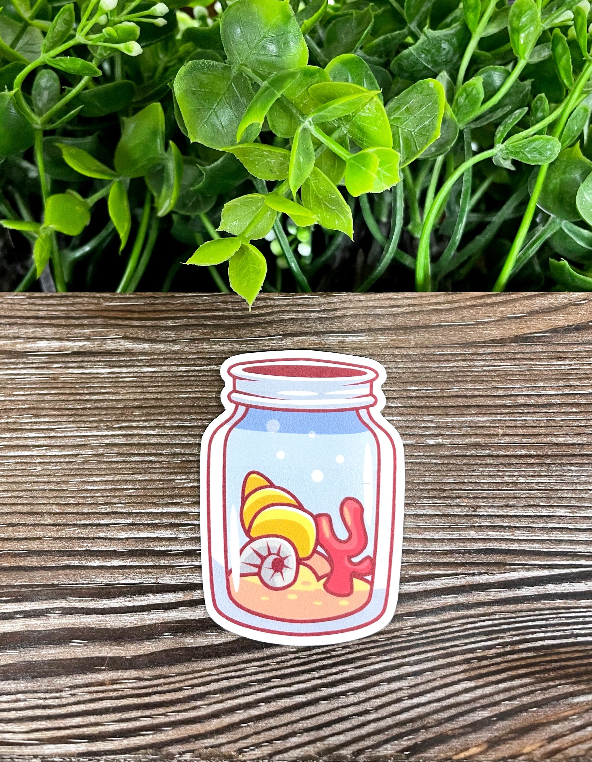 A vibrant die cut vinyl sticker featuring seashells in a mason jar, showcasing a boho design perfect for personalizing various items.