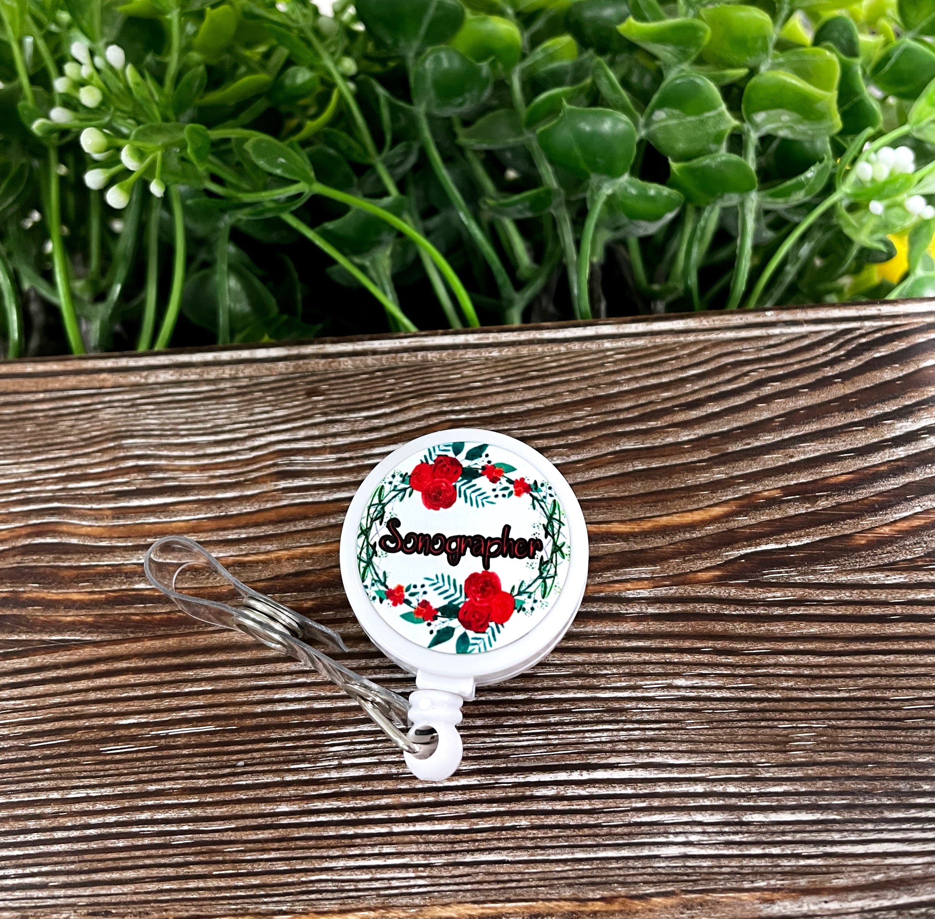 Colorful retractable badge reel featuring sonographer flowers design, showcasing a boho style with a durable metal and plastic construction.