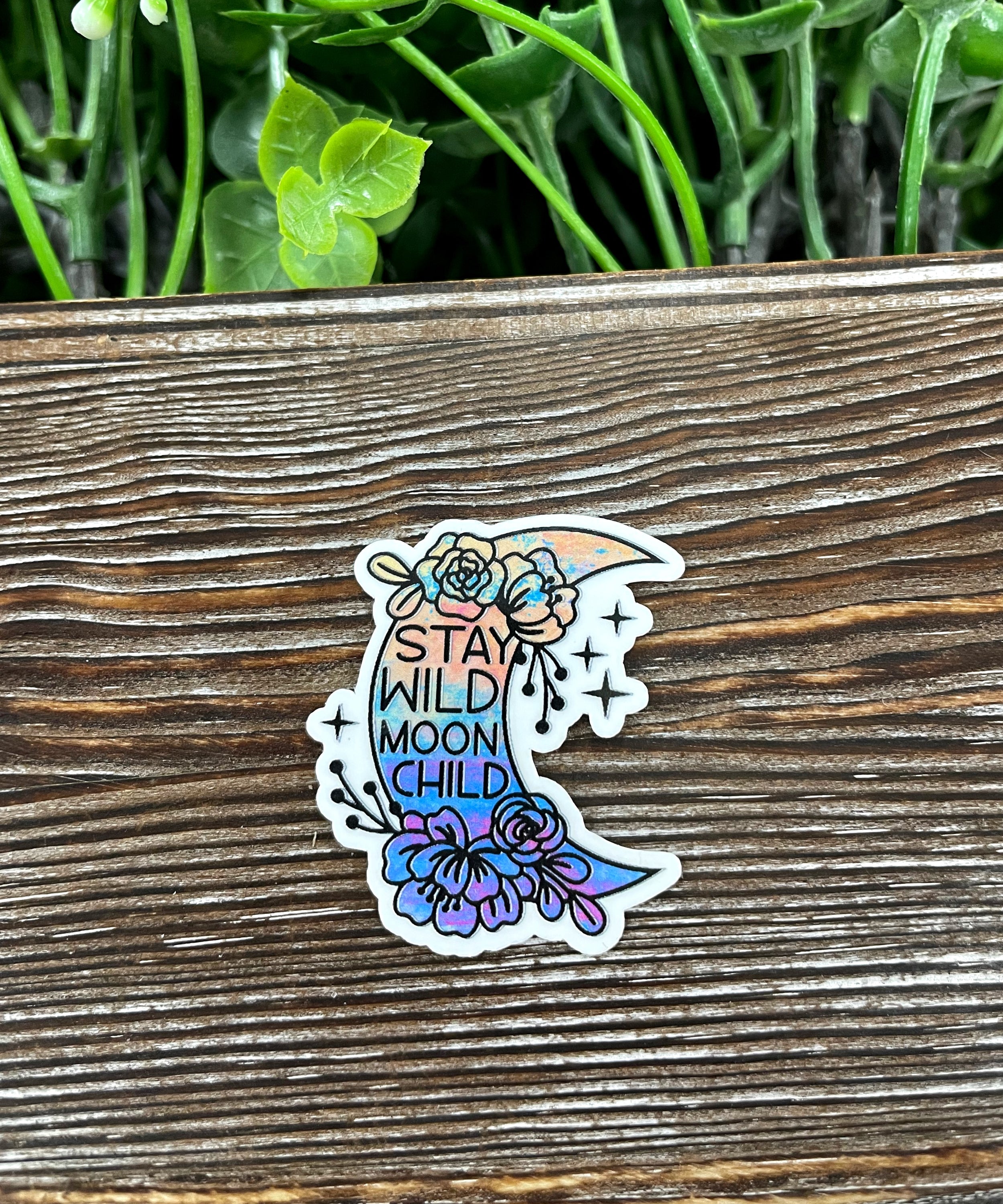 Stay Wild Moon Child Sticker featuring a whimsical design, perfect for personalizing smooth surfaces like notebooks and water bottles.