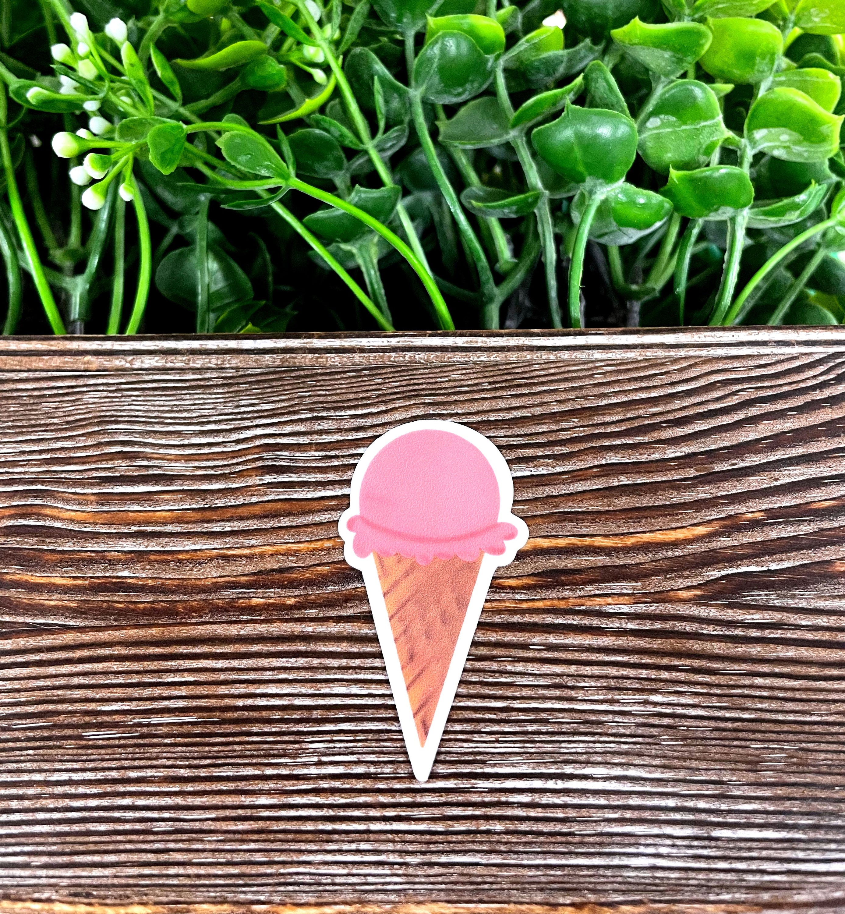 A colorful die cut sticker featuring a strawberry ice cream cone design, perfect for personalizing various smooth surfaces.