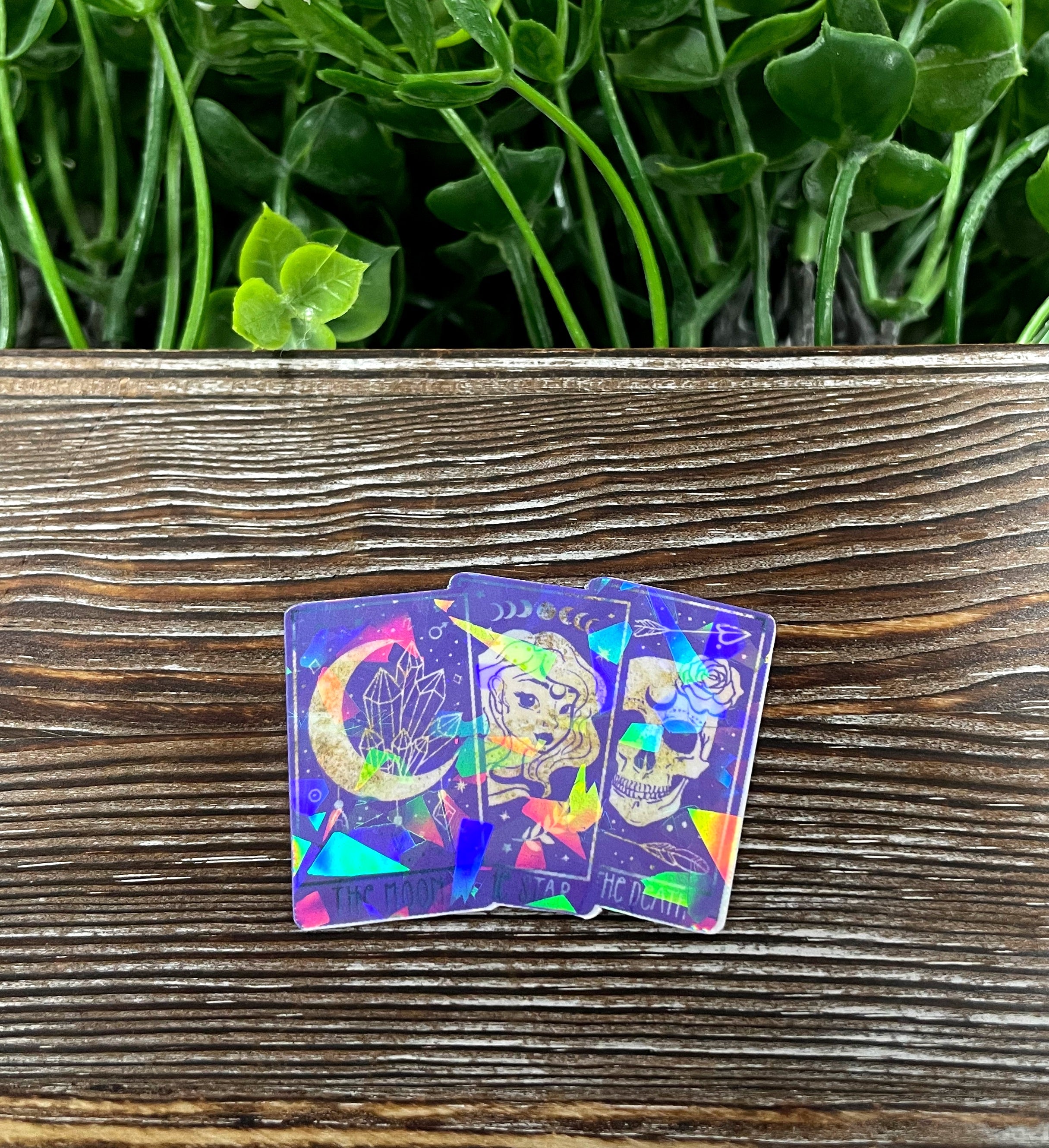 Purple and gold tarot cards graphic art sticker on a smooth surface, showcasing intricate designs and vibrant colors.