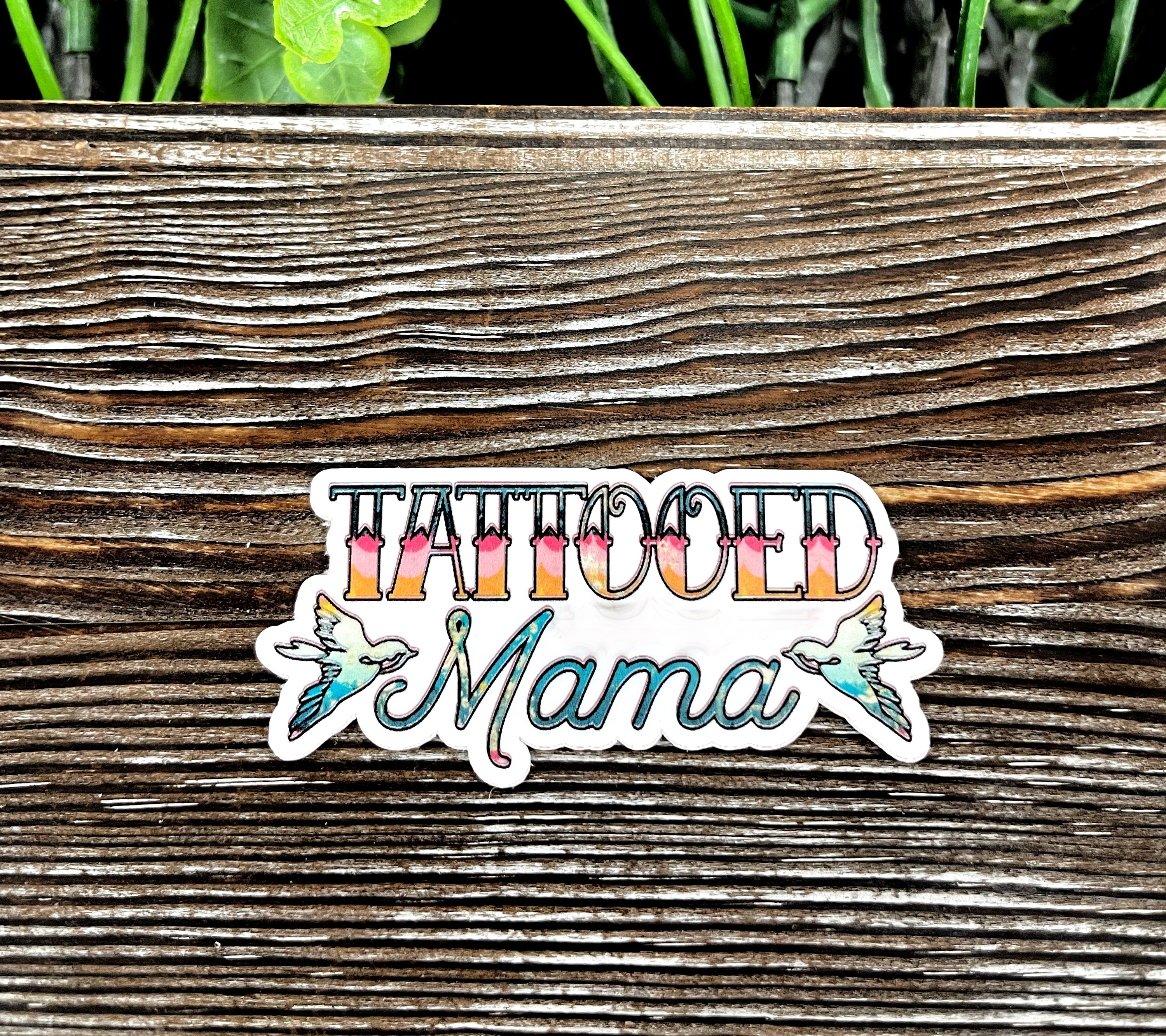 Tattooed Mama Die Cut Sticker on a smooth surface, showcasing vibrant colors and intricate graphic art design.