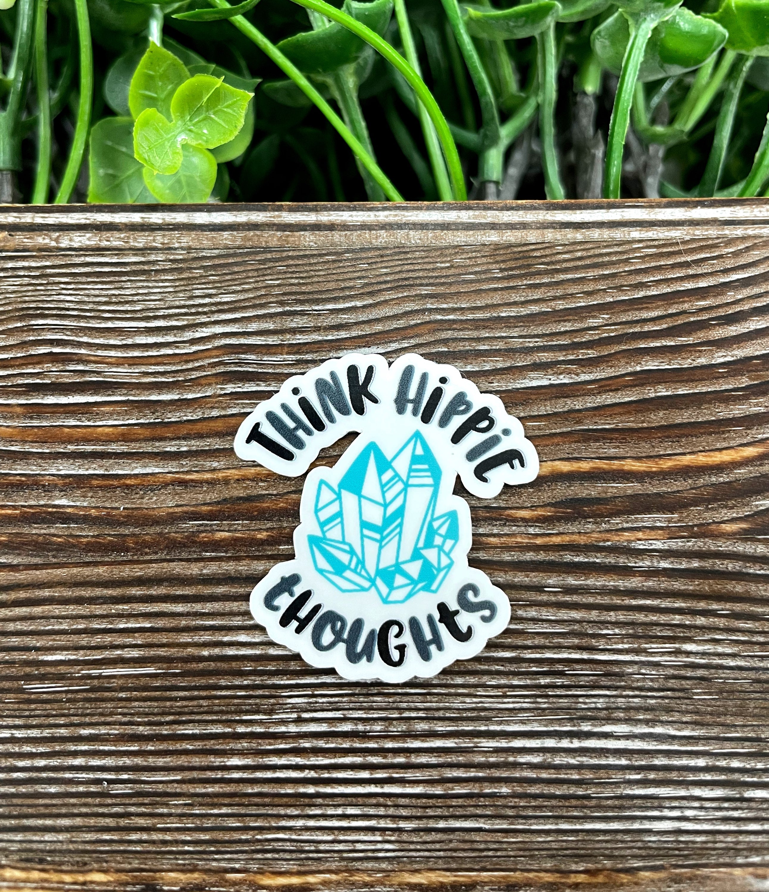Think Hippie Thoughts die cut sticker on a smooth surface, showcasing vibrant colors and graphic art design.