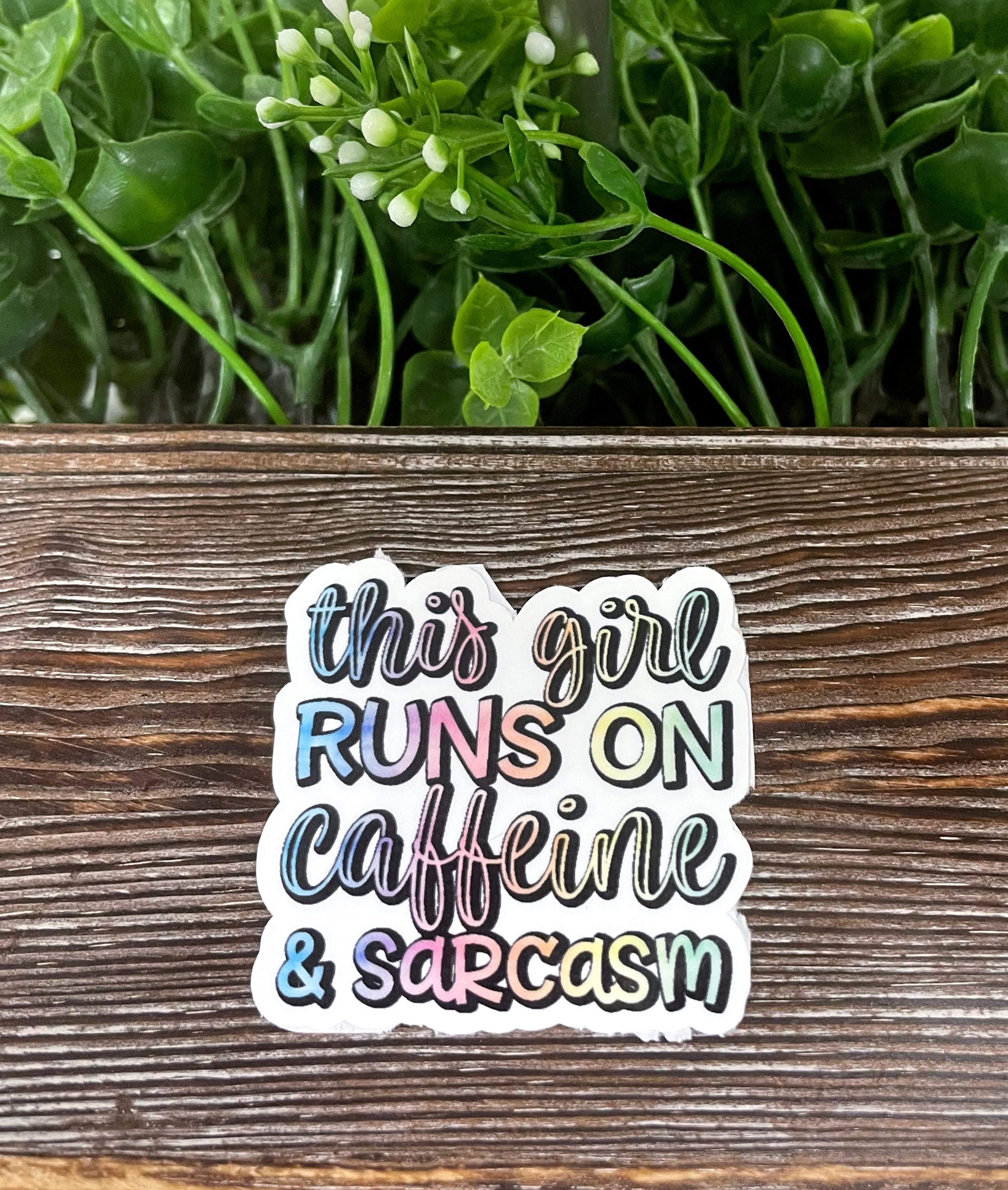 Die cut sticker featuring the quote 'This Girl Runs on Caffeine and Sarcasm' with a playful design, perfect for personalizing items.