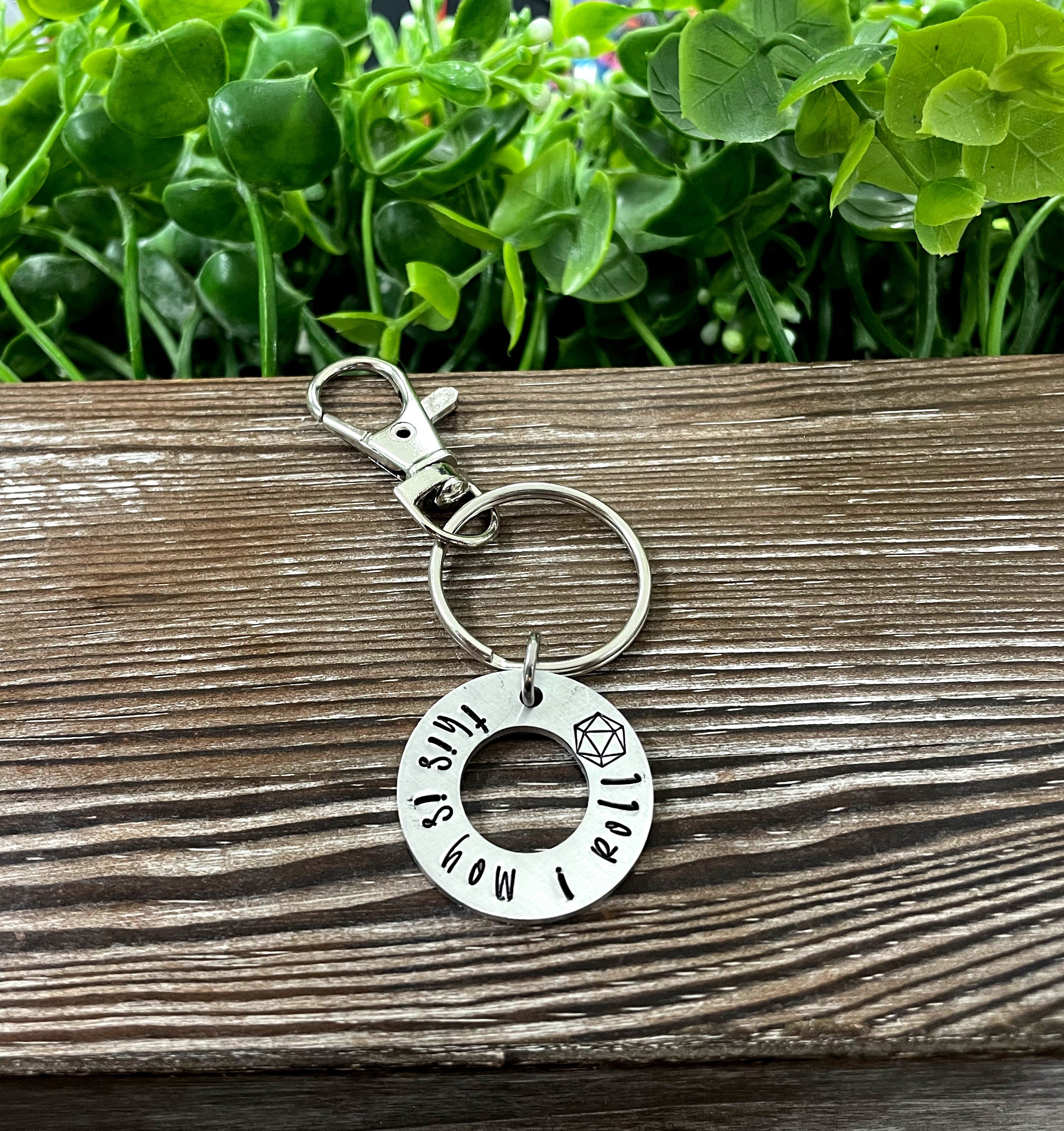 Hand-stamped key chain featuring the phrase 'This is how I roll' with a gamer dice theme, showcasing unique craftsmanship.