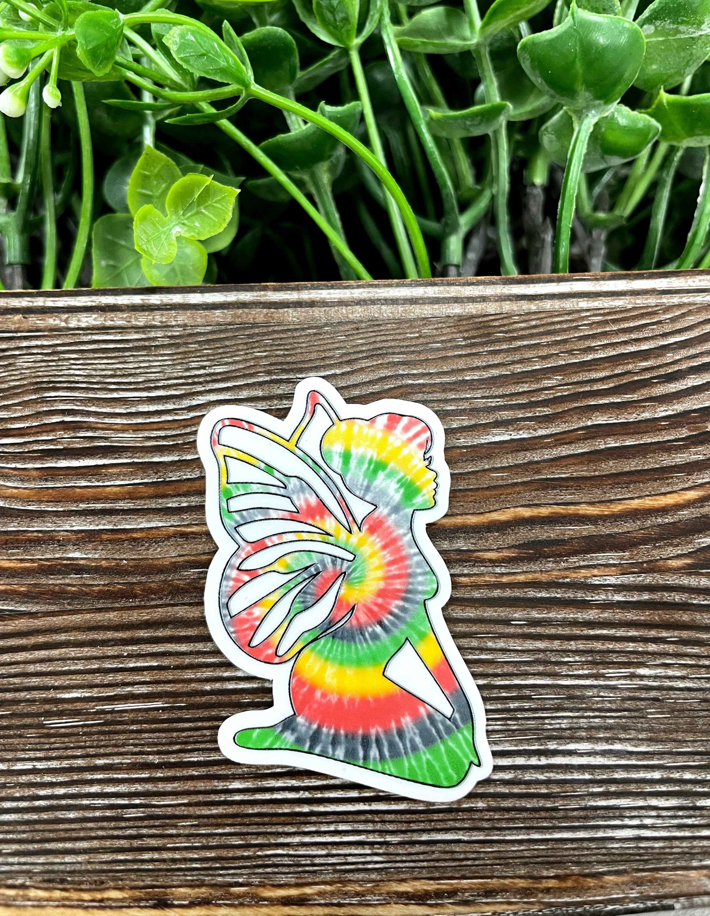 Colorful Tie Dye Fairy Die Cut Sticker on a smooth surface, showcasing vibrant colors and intricate design.