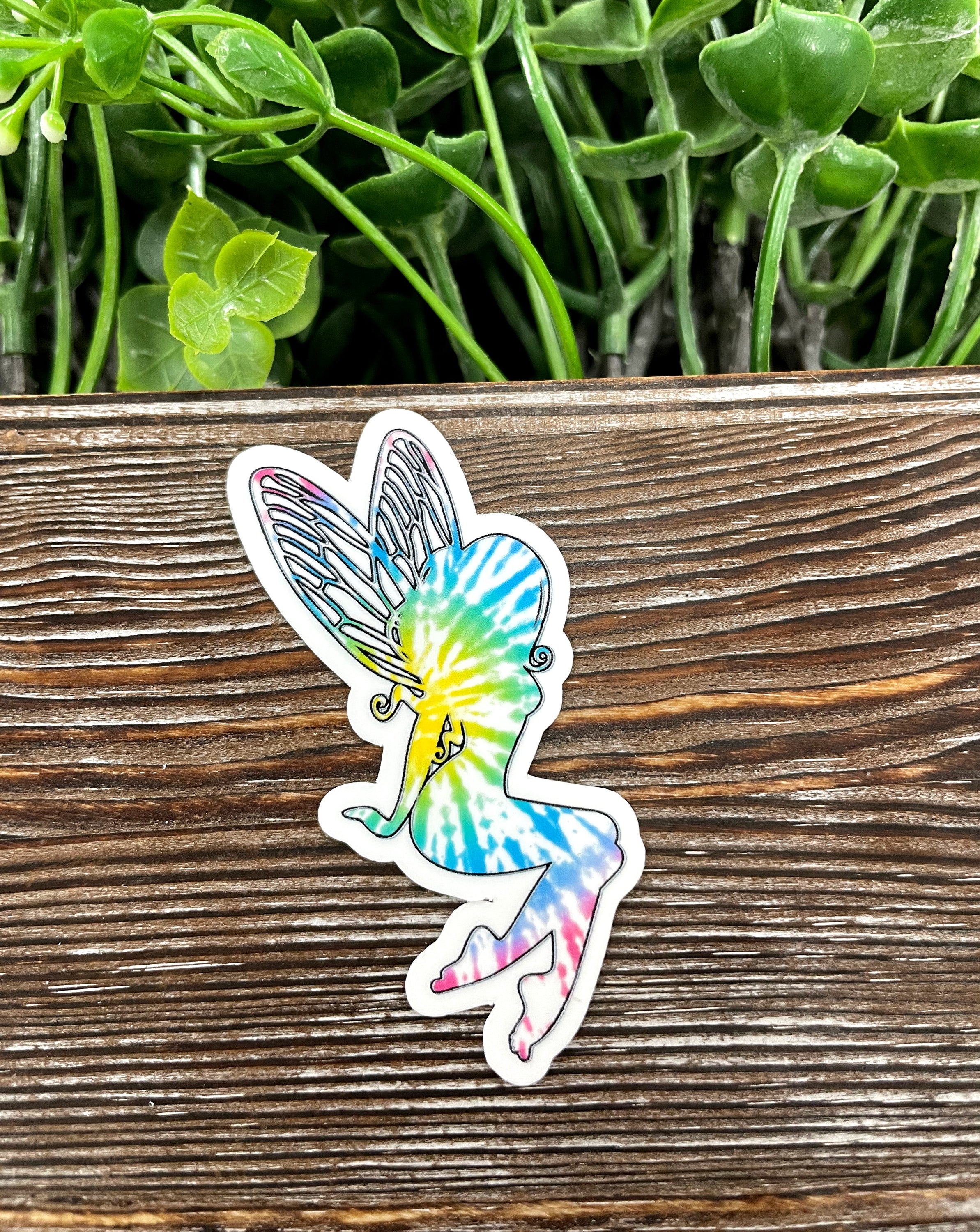 Colorful Tie Dye Fairy Die Cut Sticker on a smooth surface, showcasing vibrant colors and intricate design.