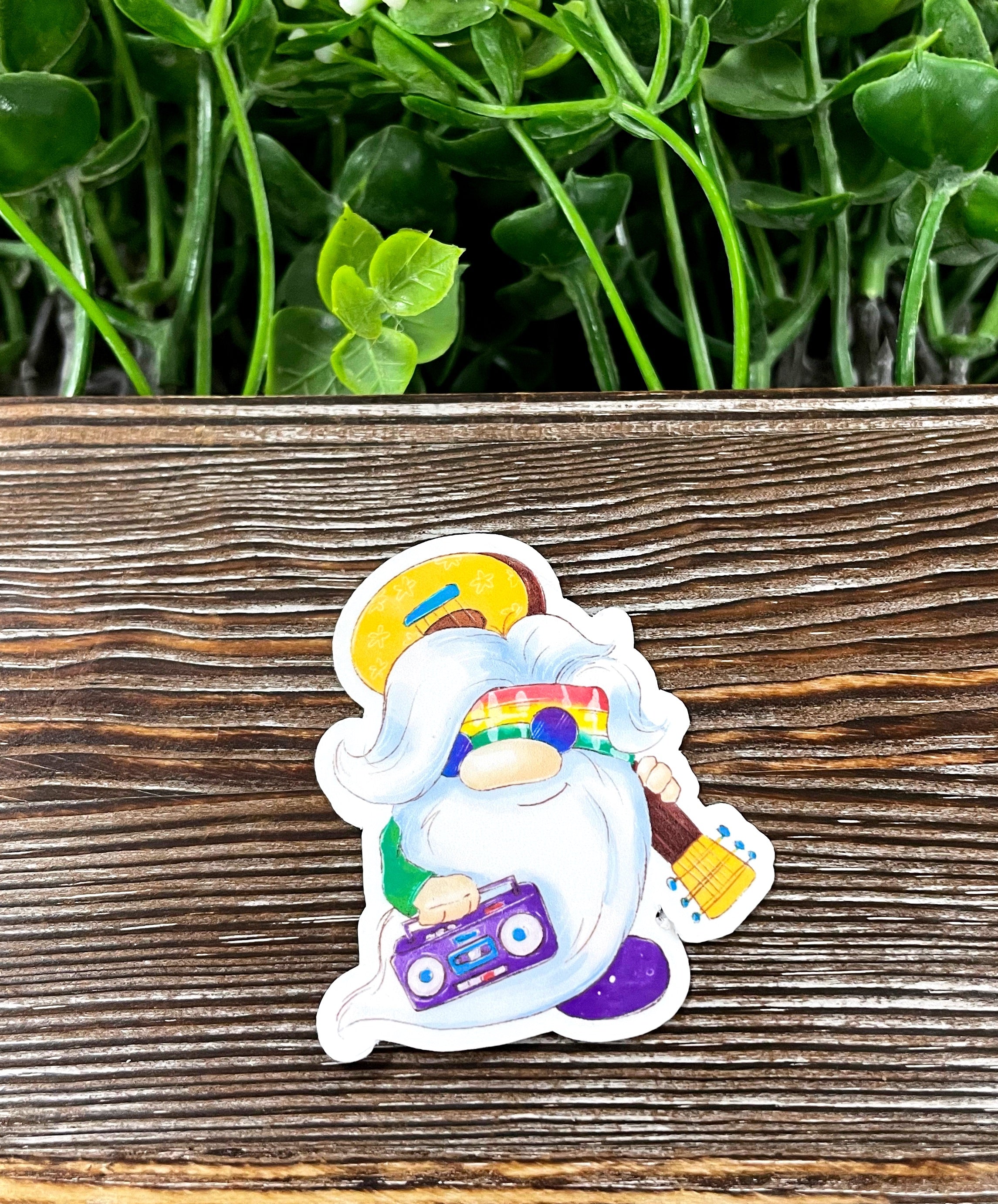 Colorful tie dye gnome sticker featuring a hippie musician design, perfect for personalizing various surfaces.