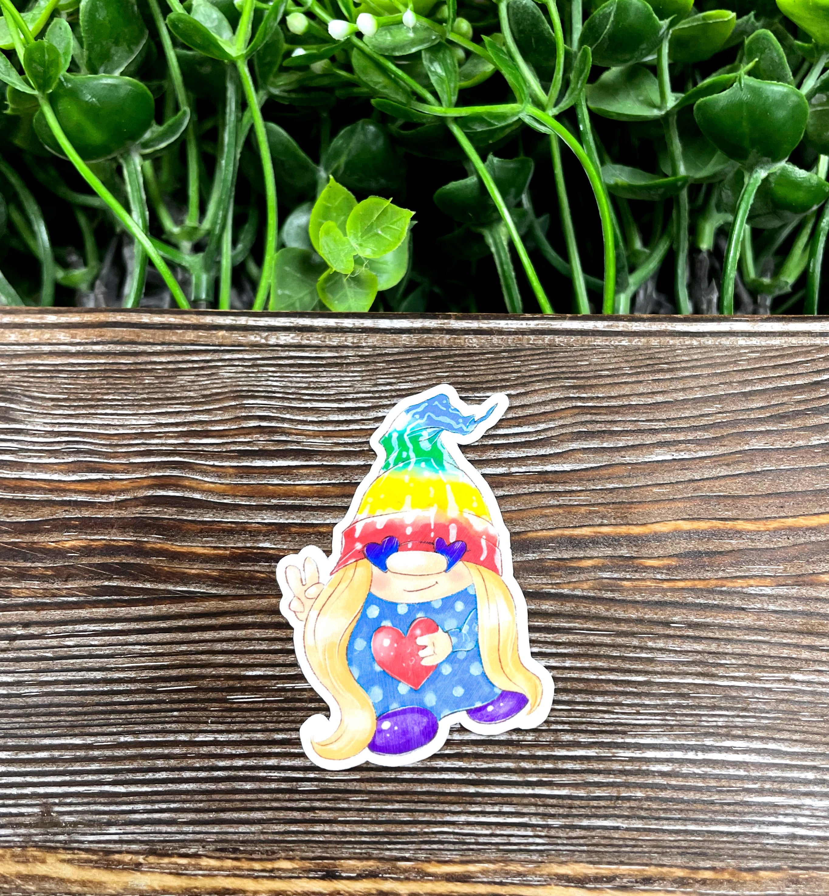 Colorful tie dye gnome sticker on a smooth surface, showcasing vibrant colors and intricate design.