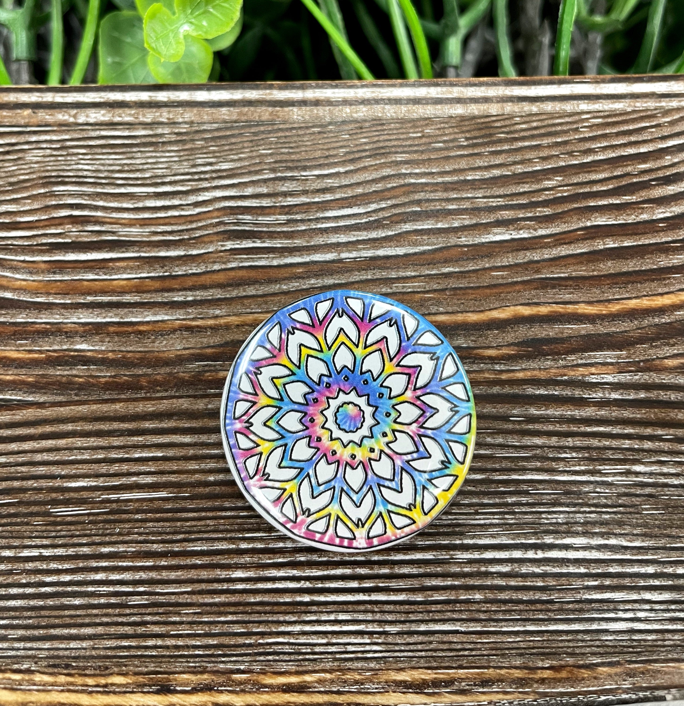 A colorful 1.25-inch tie dye mandala graphic art button with a plastic back, showcasing intricate patterns.