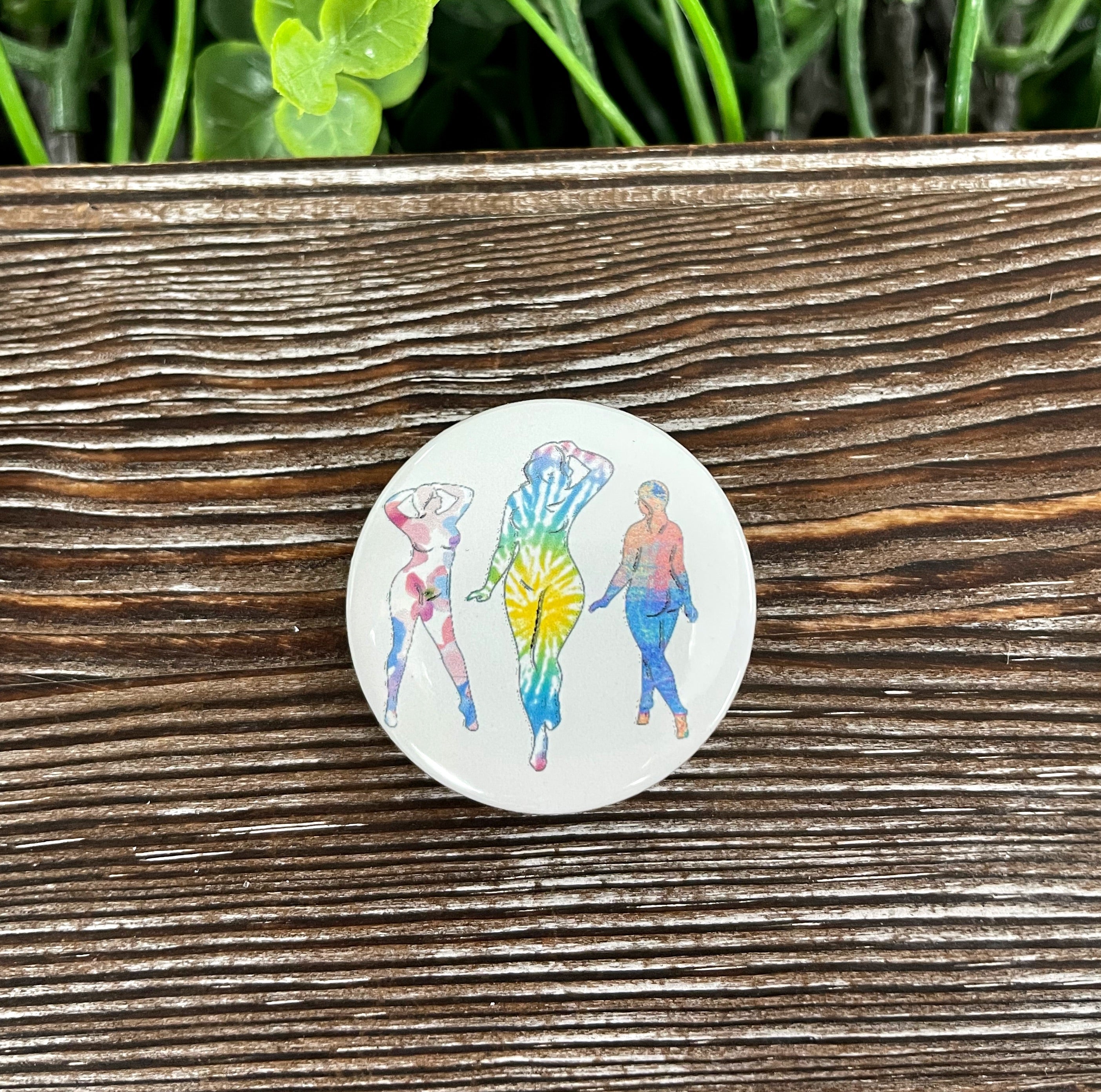 A colorful tie dye button featuring a sexy woman silhouette, measuring 1.25 inches, perfect for personalizing bags and accessories.