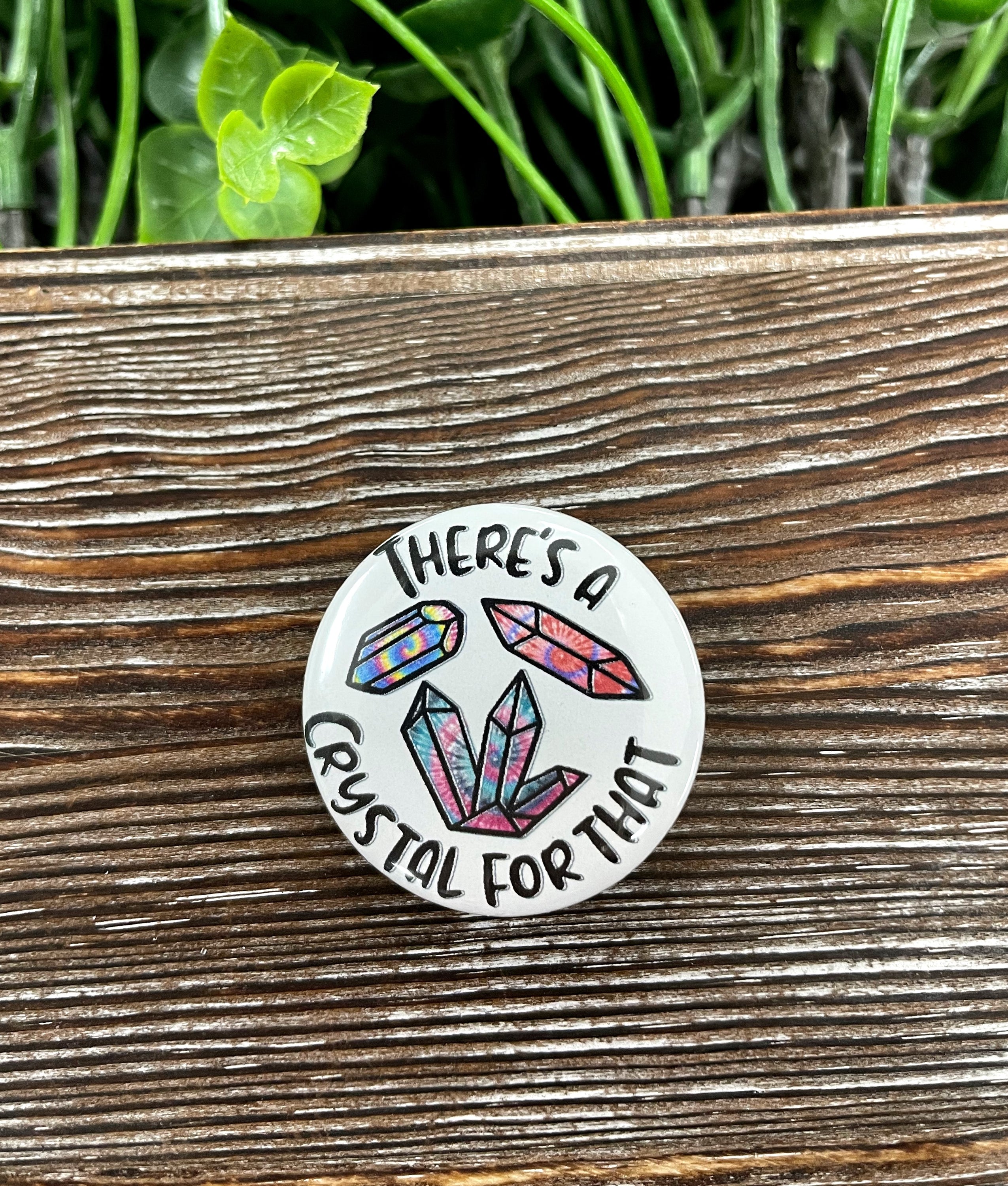 Colorful tie-dye graphic art button pin, 1.25 inches, with a plastic back, showcasing a unique crystal design.