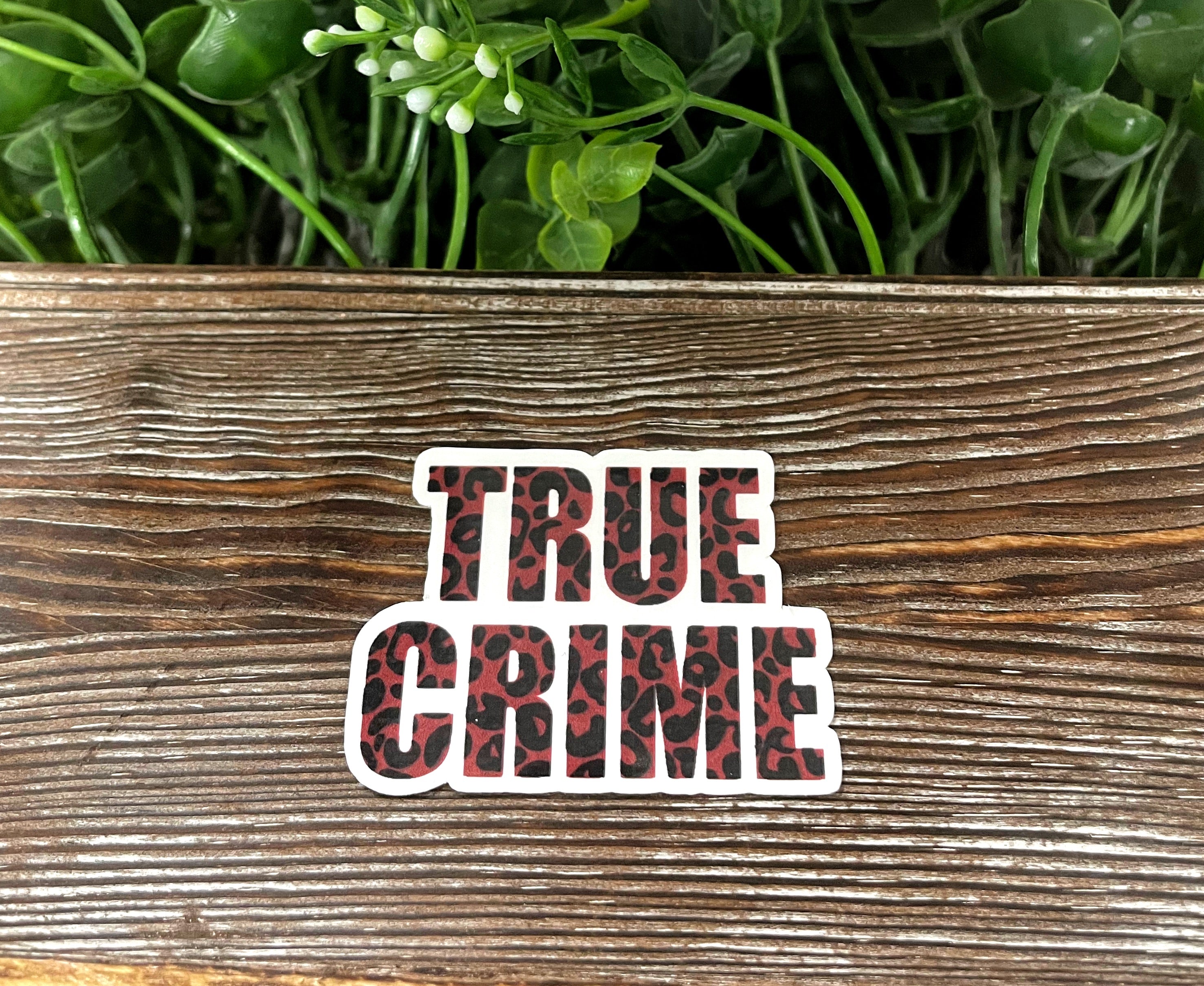 A vibrant die cut sticker featuring true crime graphic art, perfect for personalizing items like notebooks and water bottles.