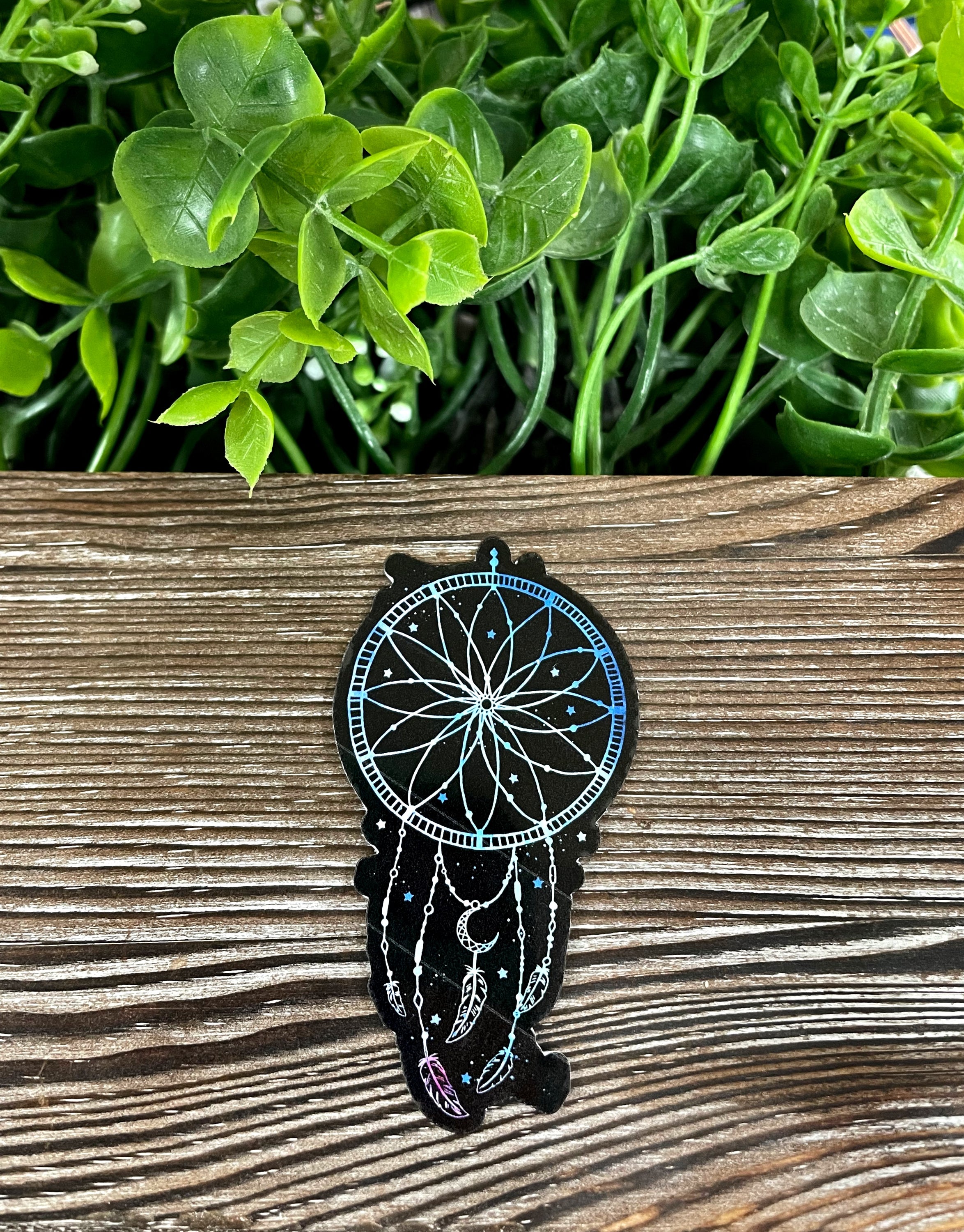 A vibrant watercolor dreamcatcher vinyl sticker featuring feathers, ideal for personalizing various smooth surfaces.