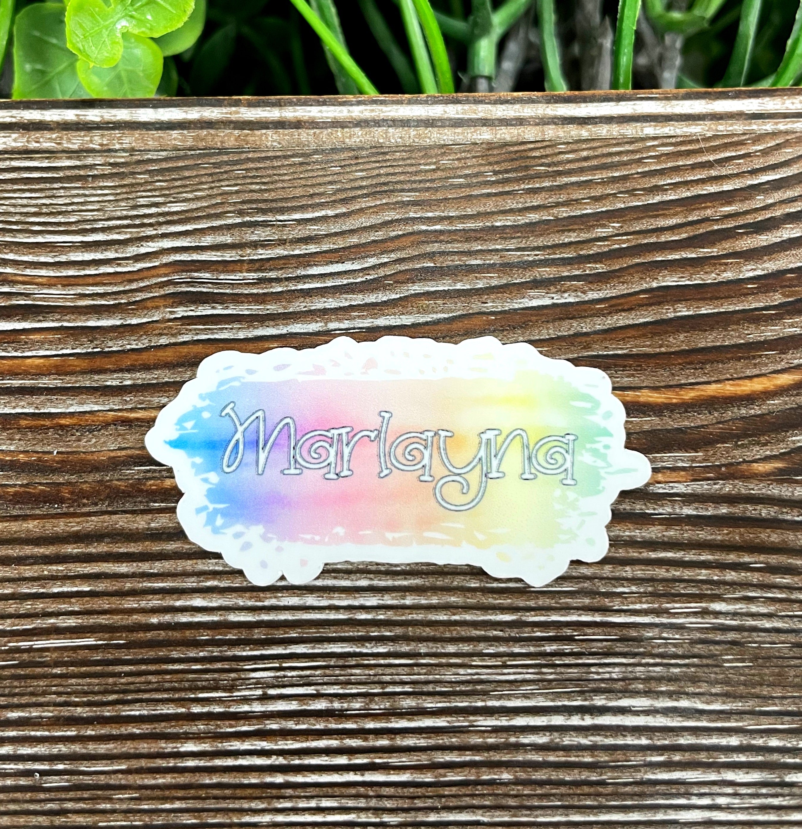 Colorful Watercolor Name Die Cut Sticker on a smooth surface, showcasing artistic design and vibrant colors.
