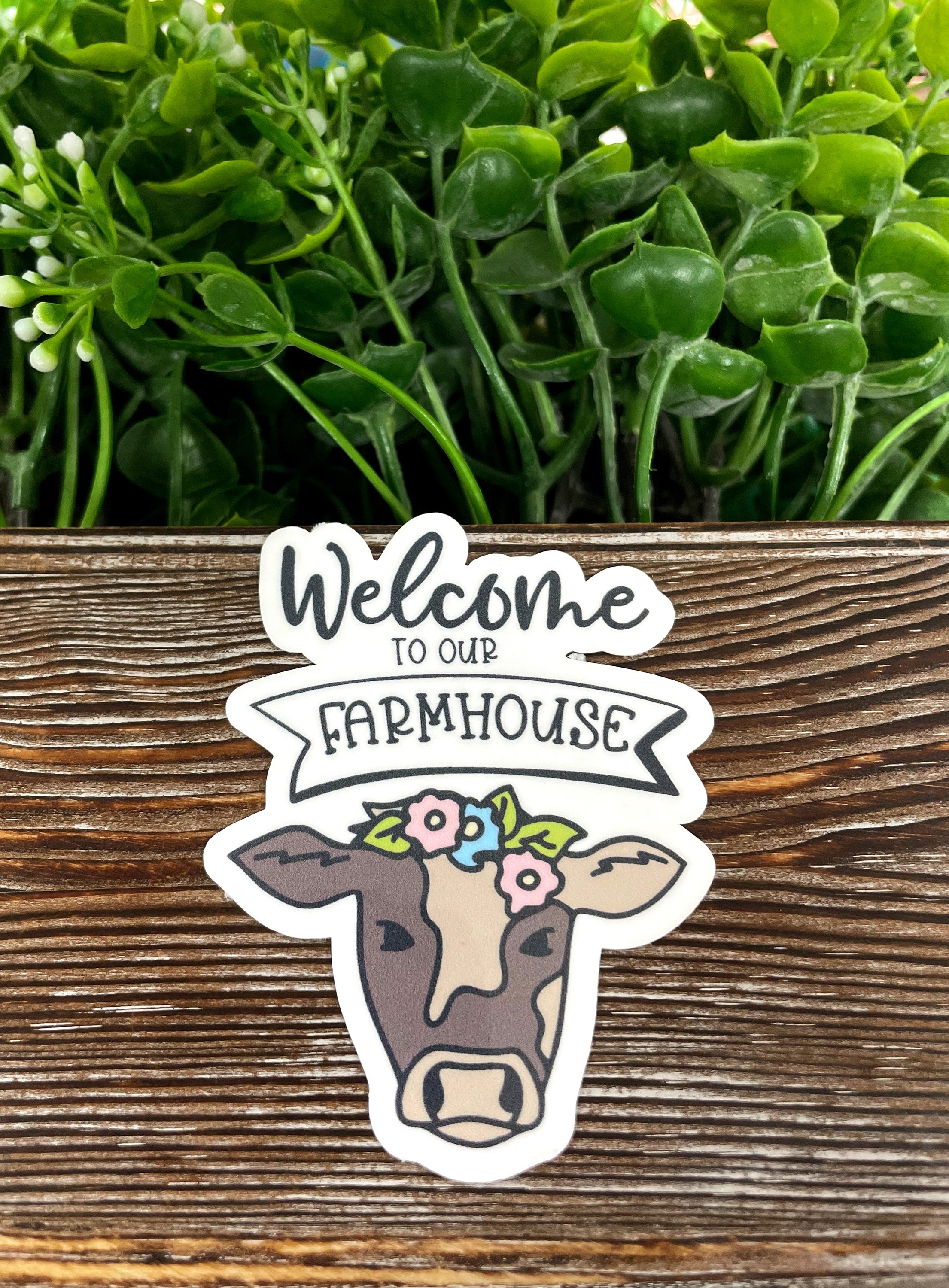 A colorful die cut vinyl sticker featuring a farmhouse cow design, perfect for personalizing water bottles and notebooks.