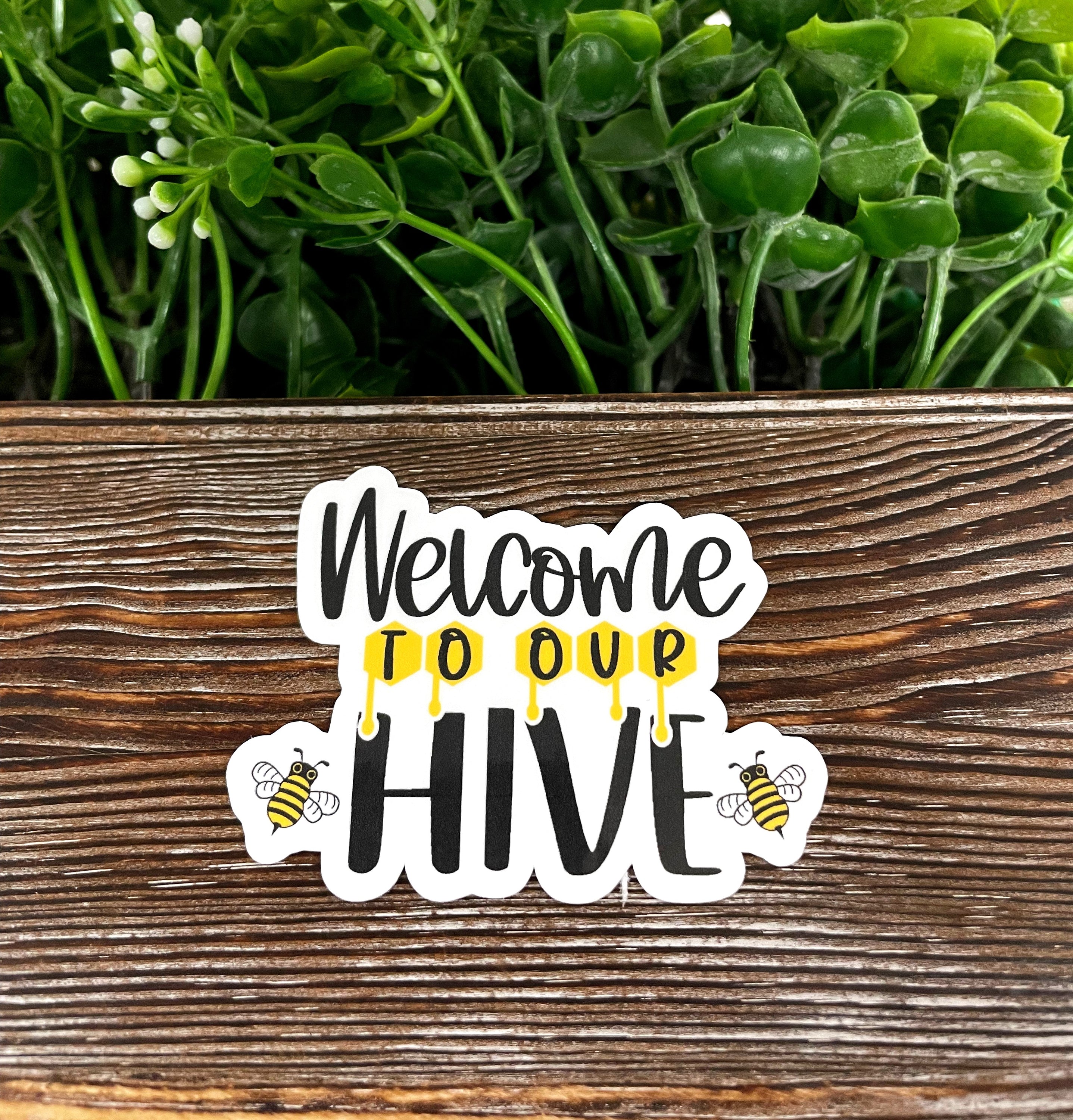 Colorful Welcome to our Hive die cut sticker on a smooth surface, showcasing boho graphic art design.