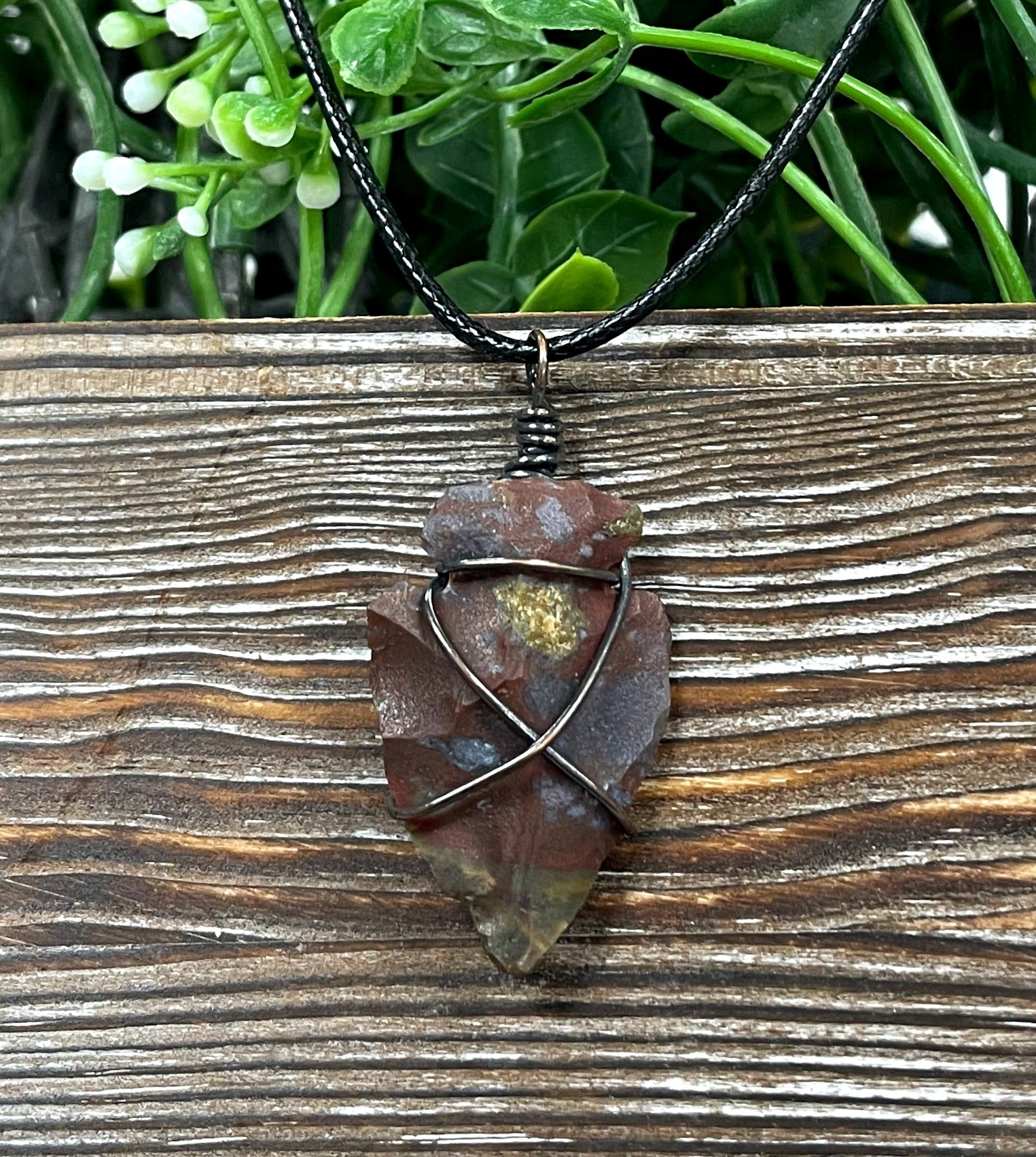 Wire Wrapped Arrowhead Pendant featuring an arrowhead wrapped in oxidized copper wire on a 21-inch cord, showcasing an antique look.
