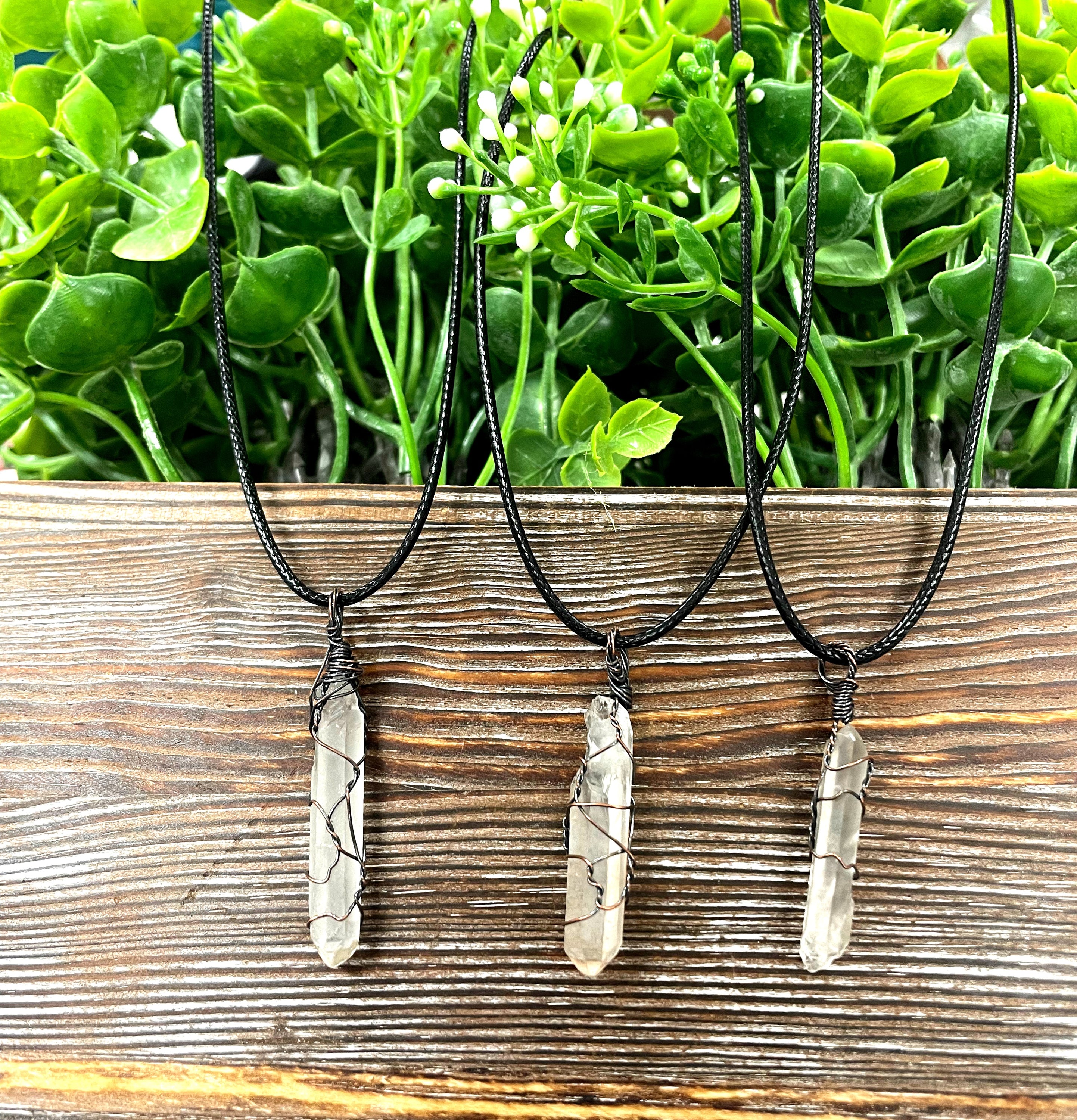 Wire Wrapped Clear Quartz Crystal Pendant with oxidized copper wire on a 21-inch cord, showcasing its antique finish and unique design.