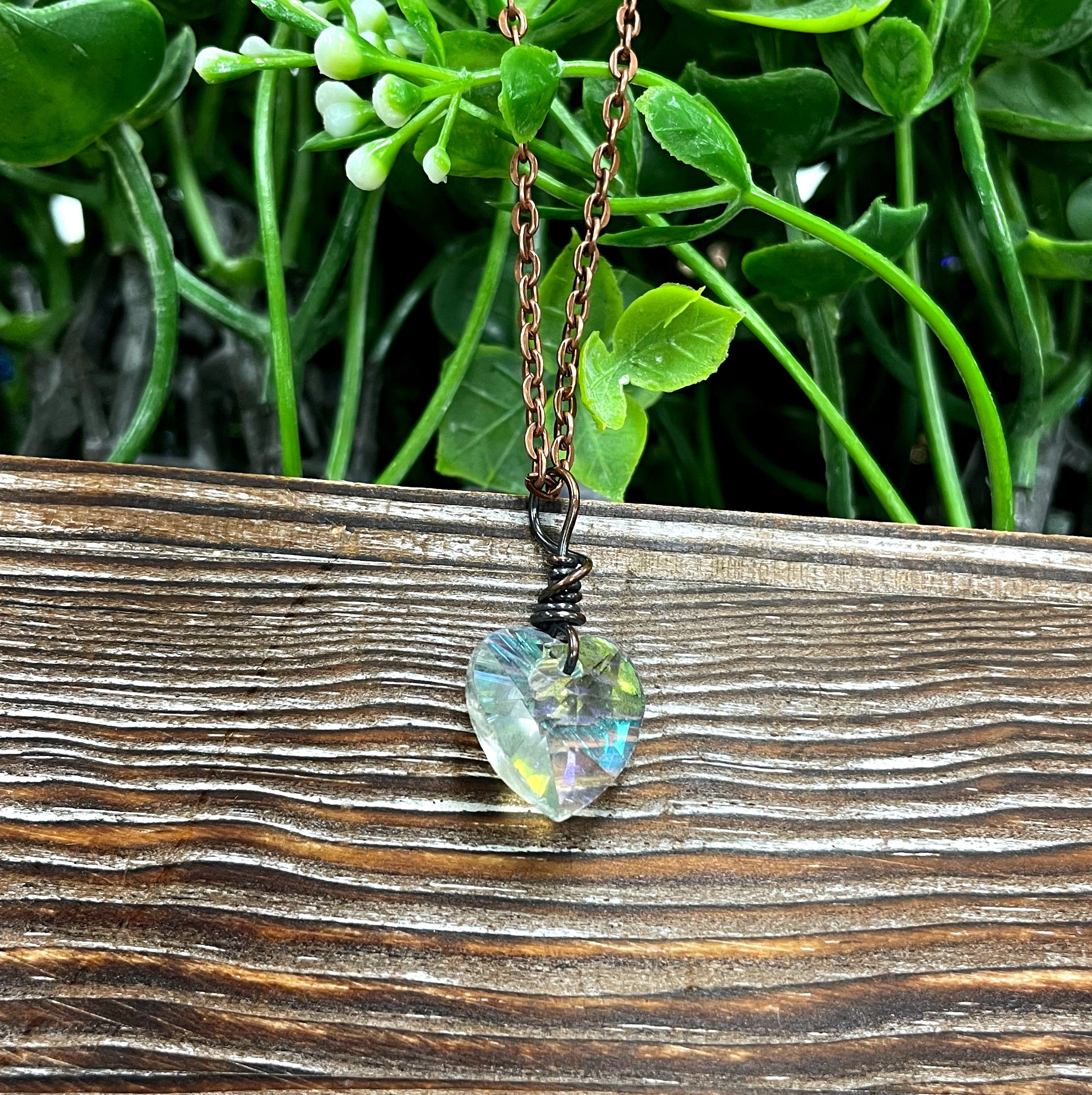 Wire Wrapped Faceted Glass Heart Crystal Pendant on a 21-inch cord, showcasing oxidized copper wire and a polished antique finish.