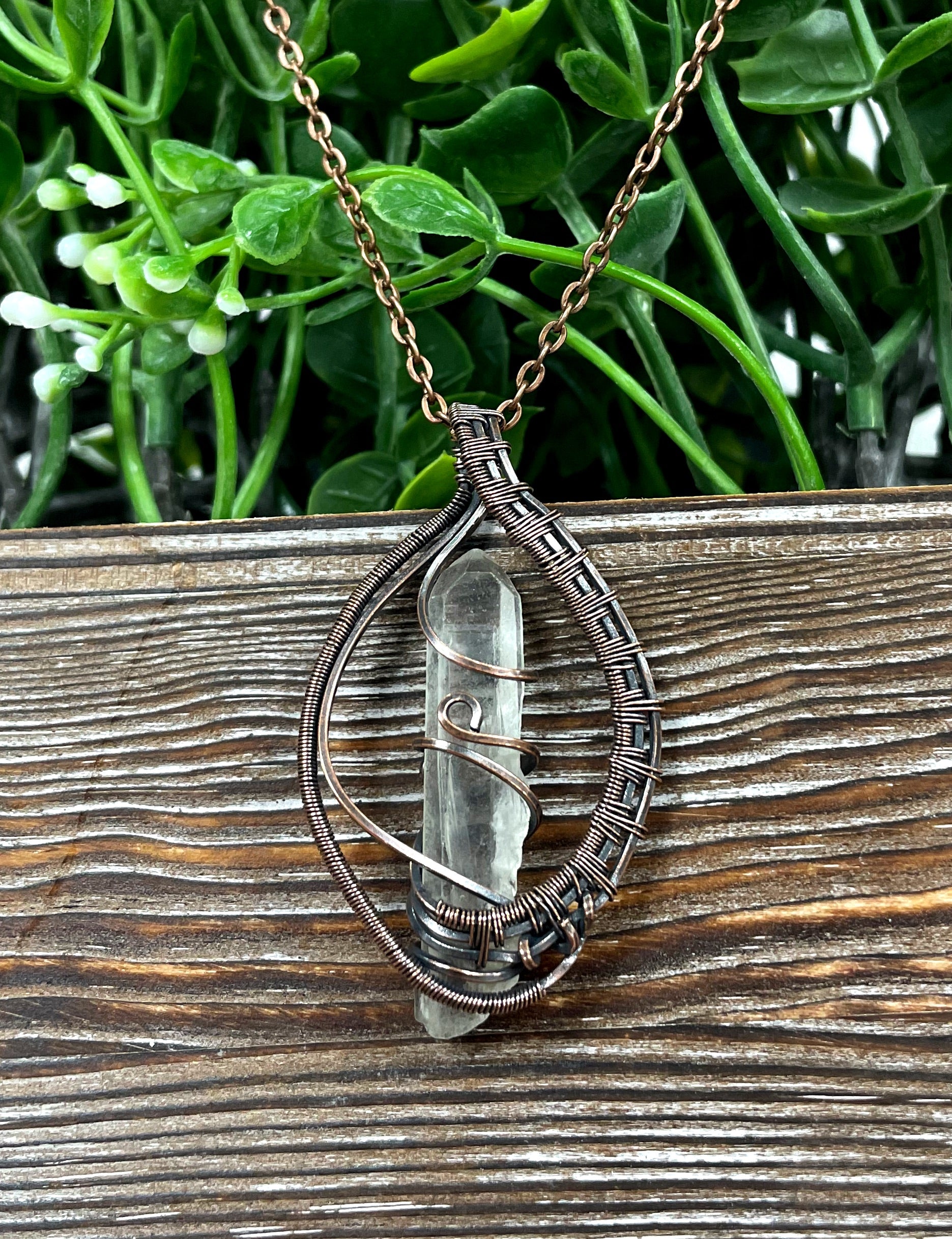 Wire Wrapped Quartz Crystal Pendant with oxidized copper wire on a 21-inch cord, showcasing its antique look and polished finish.