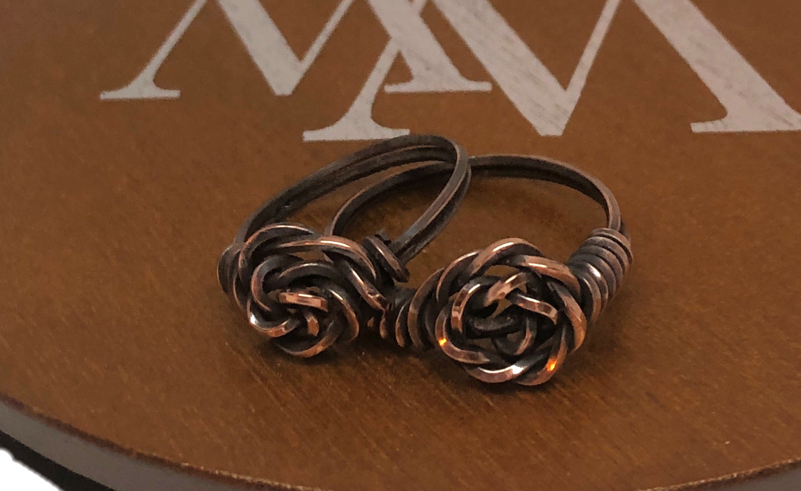 Wire Wrapped Twisted Copper Rose Ring showcasing intricate twisted design and oxidized finish, perfect for unique jewelry lovers.