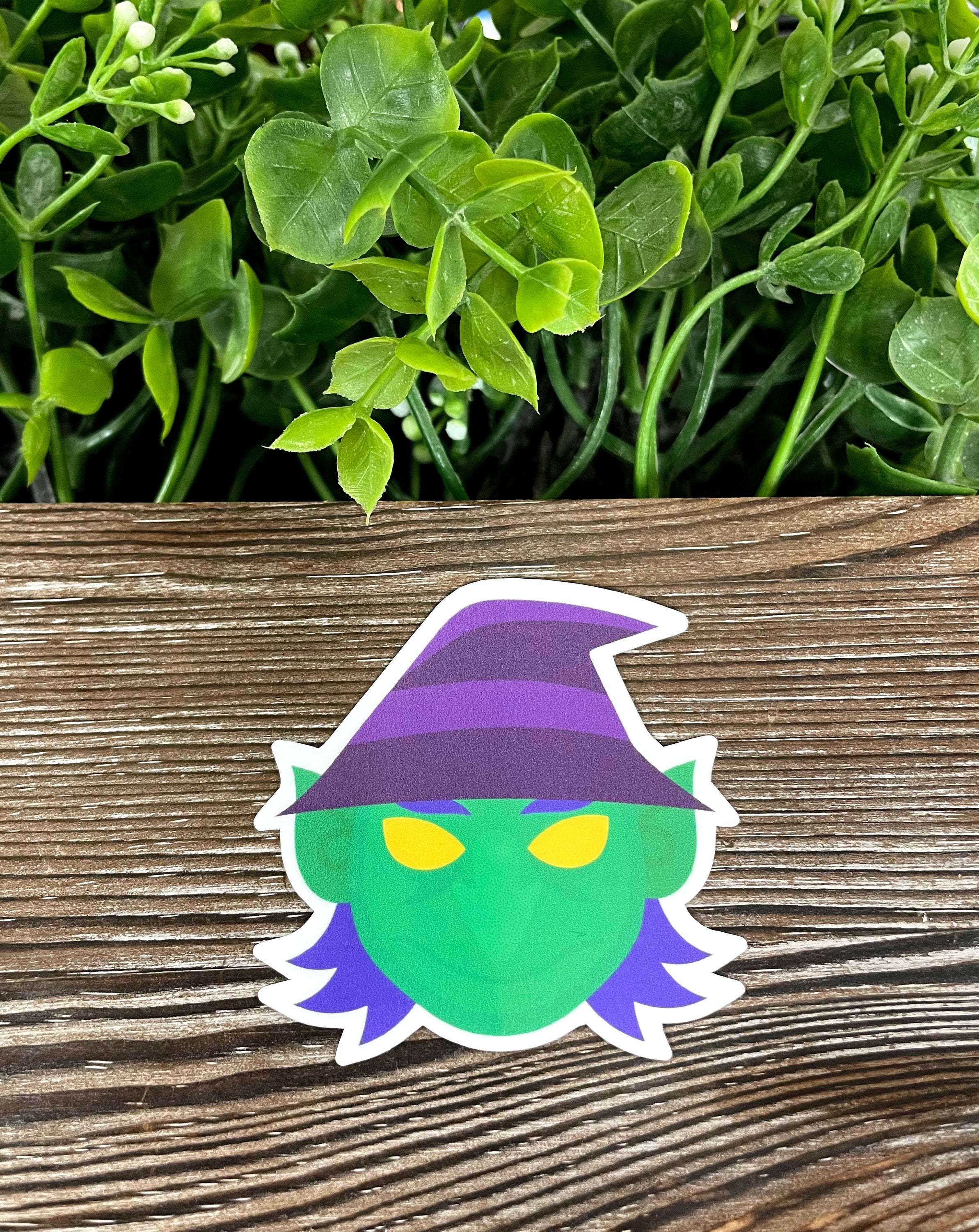 A vibrant Witch Costume die cut vinyl sticker featuring a whimsical design, perfect for personalizing smooth surfaces.