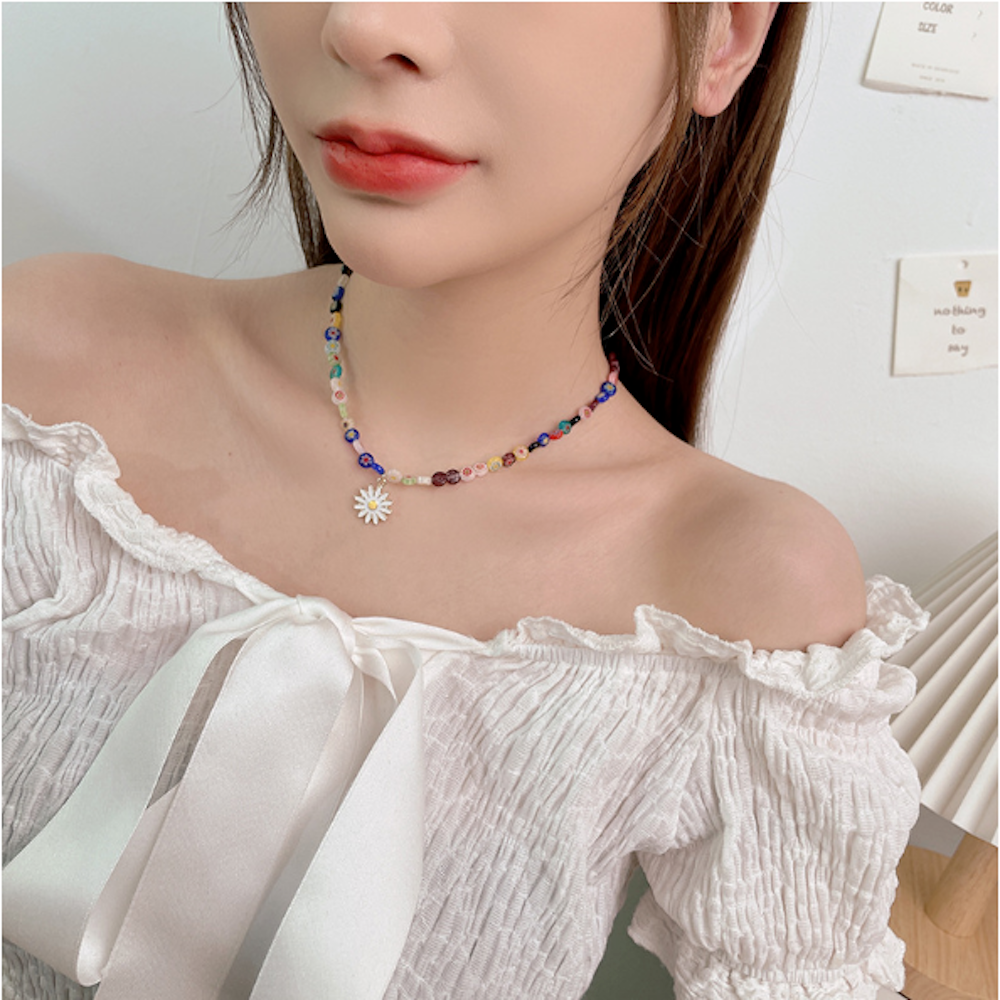 Womens Rainbow Beaded Necklace featuring a charming daisy pendant, showcasing colorful beads and a gold plated finish.