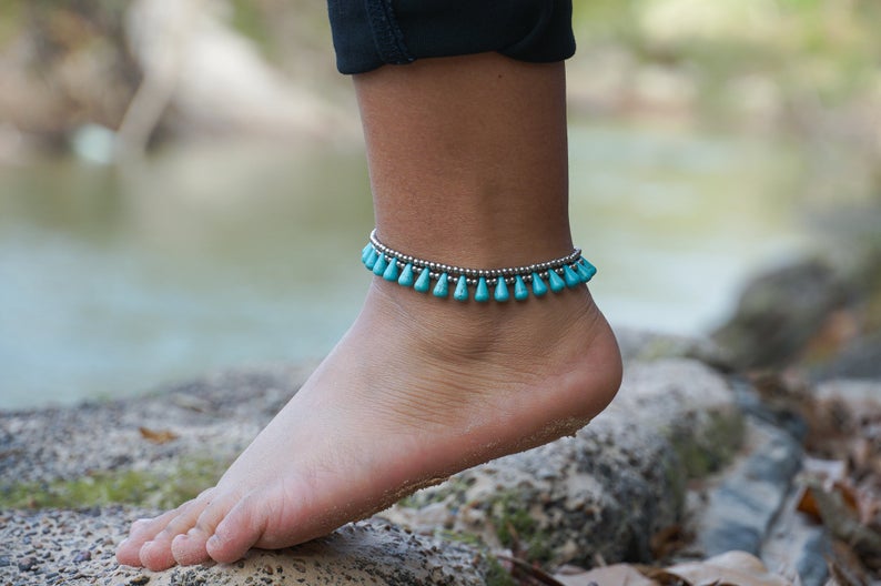 Turquoise teardrop bead boho silver anklet featuring silver bells and pressed cotton chords, handcrafted by Thai artisans.