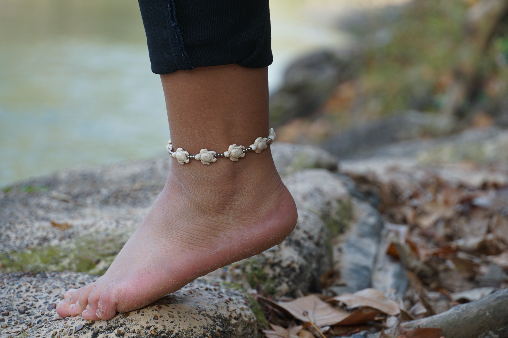 White Turtle Boho Silver Anklet featuring silver bells and pressed cotton chords, handcrafted by Thai artisans.