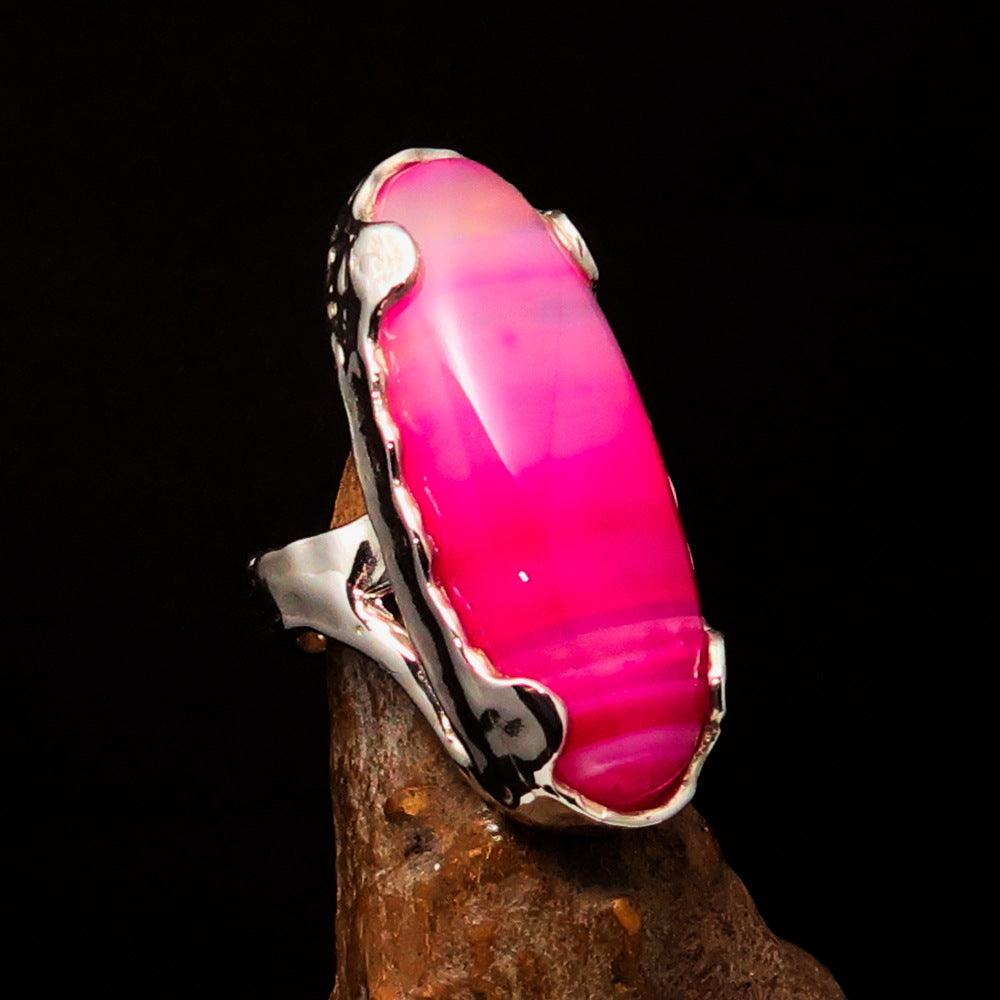 Artistic sterling silver ring featuring an oval pink Agate cabochon, polished finish, and hallmark 925.
