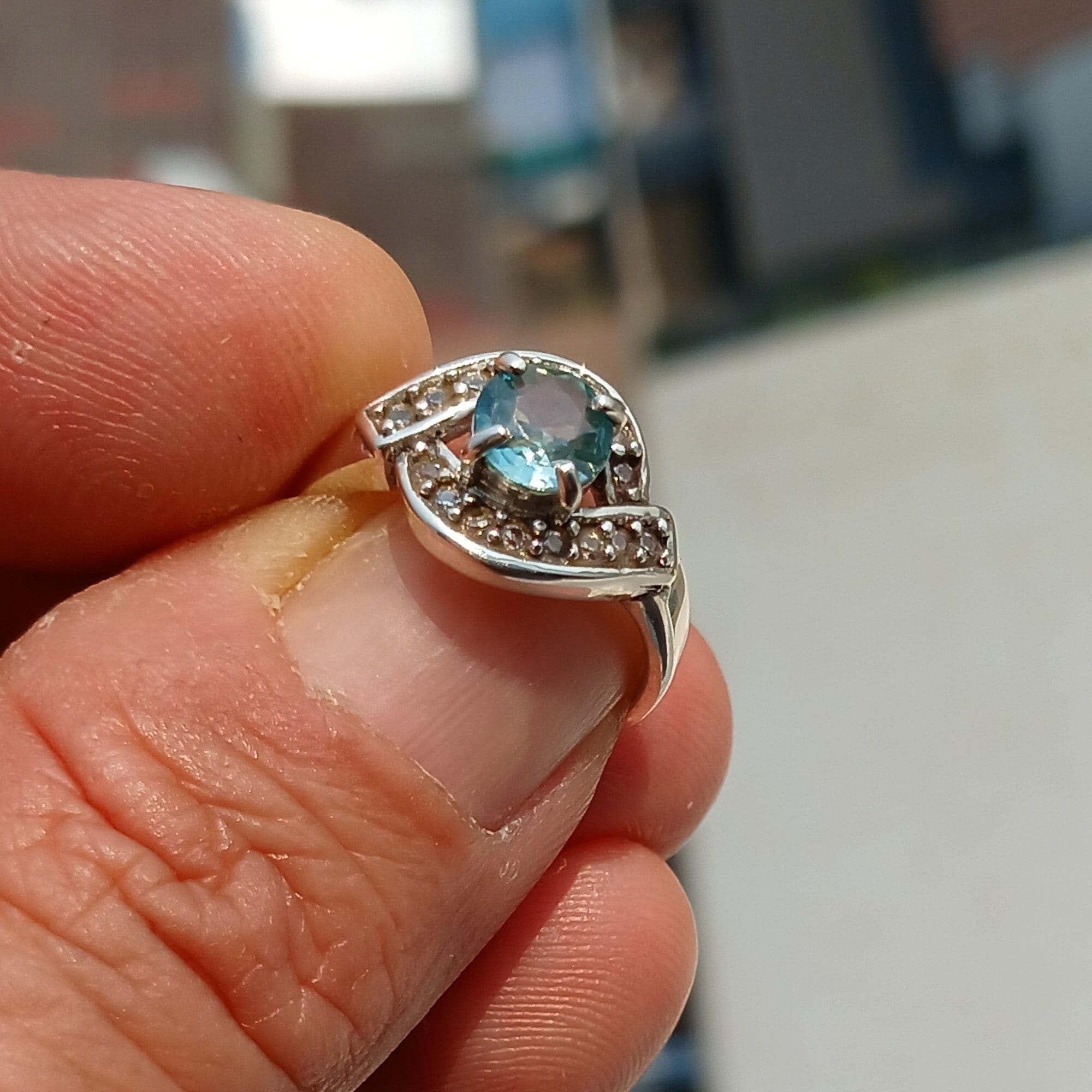 Handmade Blue Zircon Ring in sterling silver with round cut gemstone and CZ accents, showcasing elegance and craftsmanship.