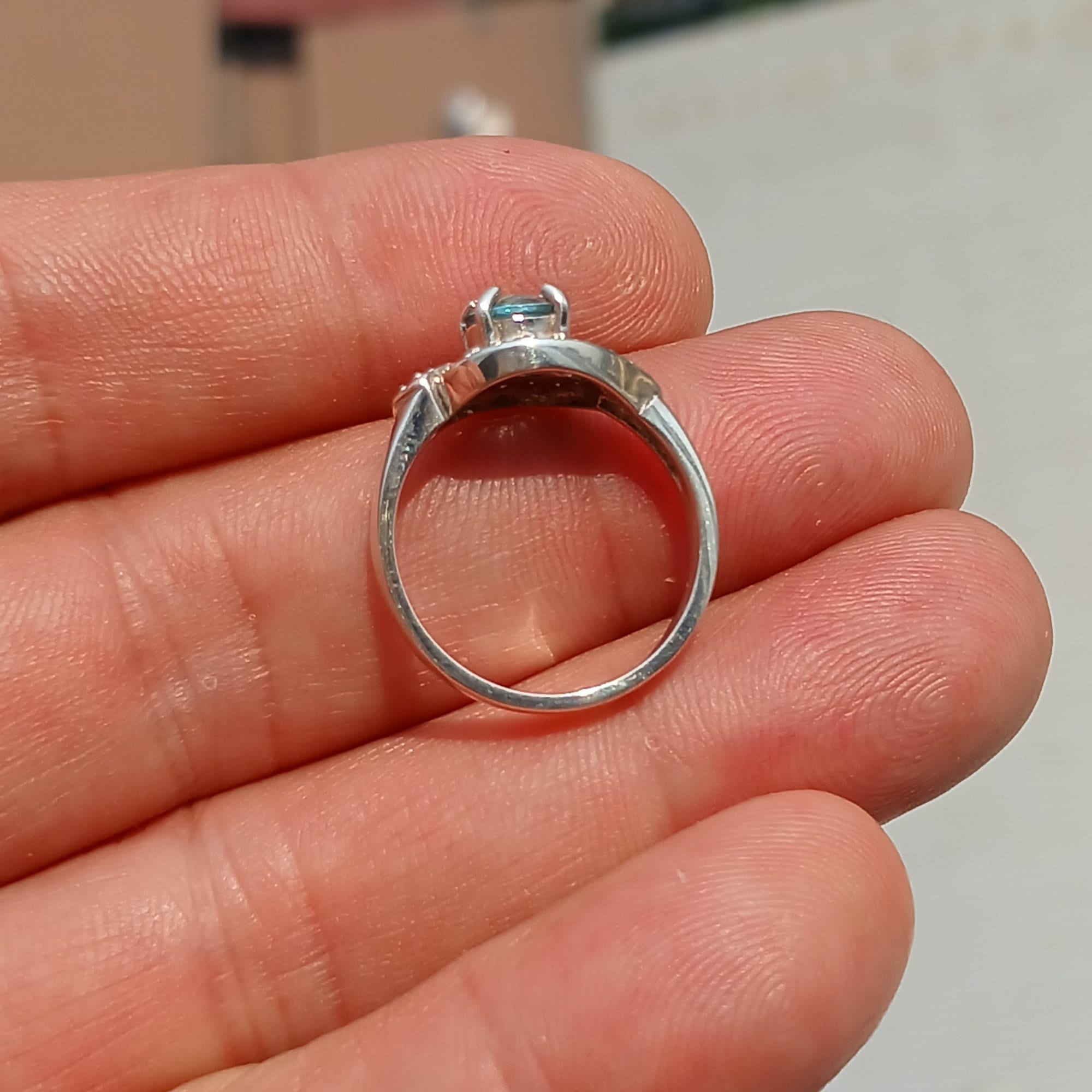 Handmade Blue Zircon Ring in sterling silver with round cut gemstone and CZ accents, showcasing elegance and craftsmanship.