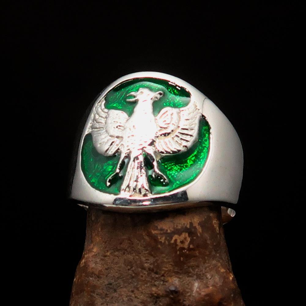 A beautifully crafted ancient men's green Garuda ring made of sterling silver, featuring intricate details and a polished enamel finish.