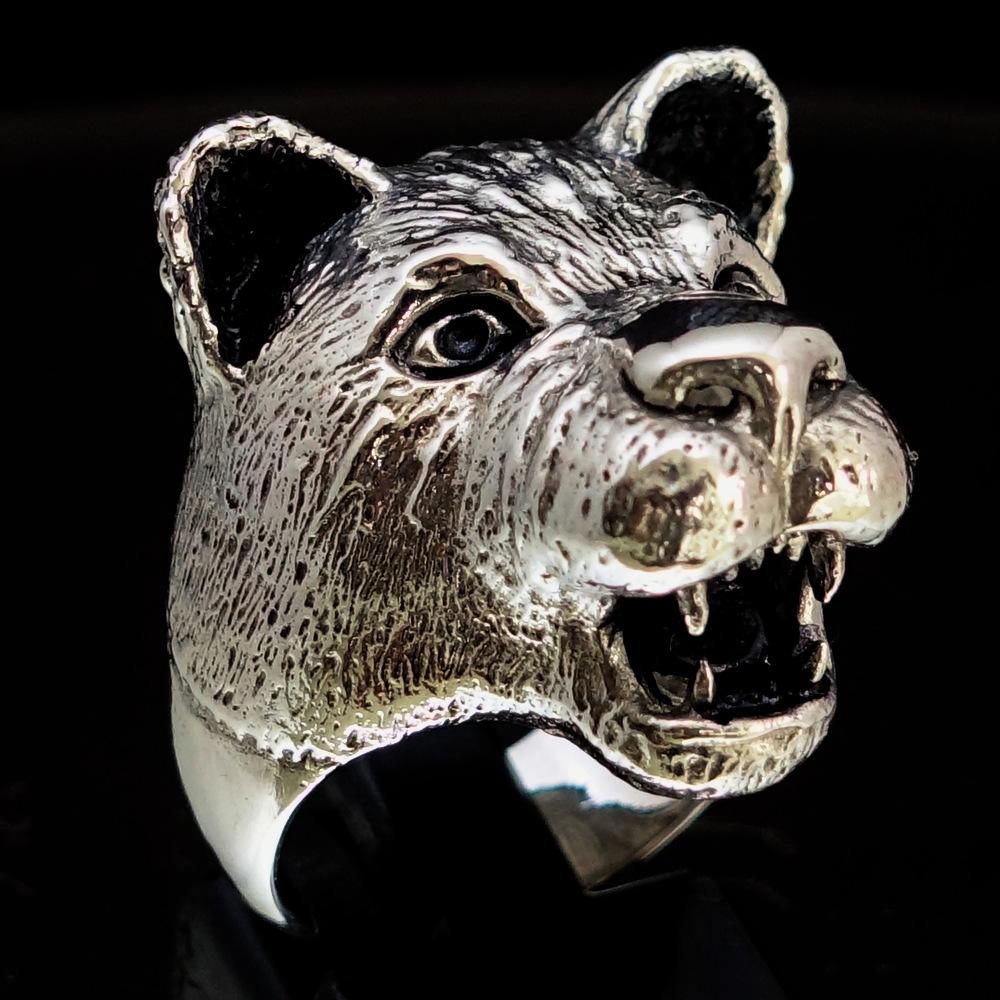 A beautifully crafted sterling silver ring featuring a female lion and lioness design, showcasing high polish and antiqued finishes.