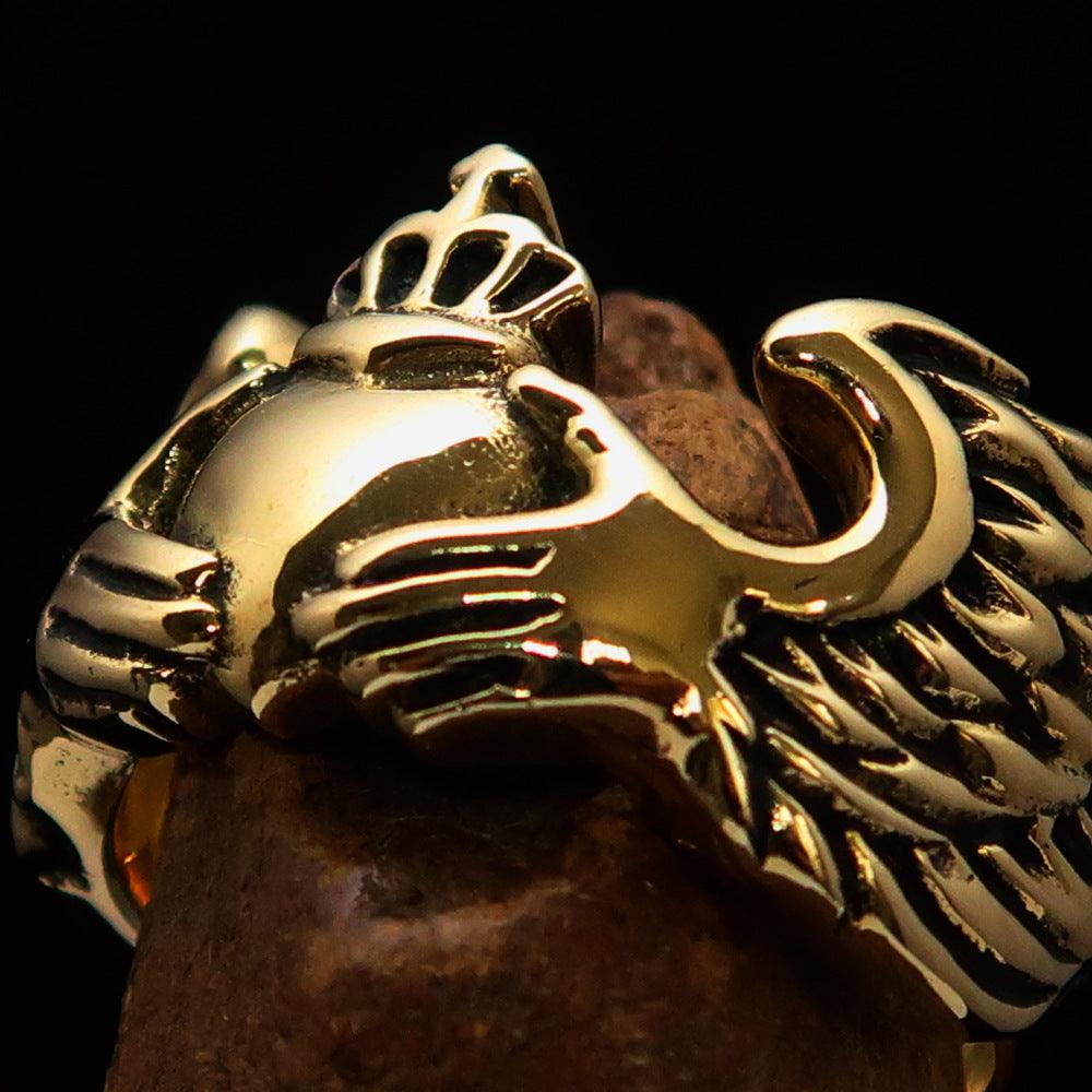 Solid brass Claddagh men's ring featuring a winged heart and crown design, polished to a high shine.