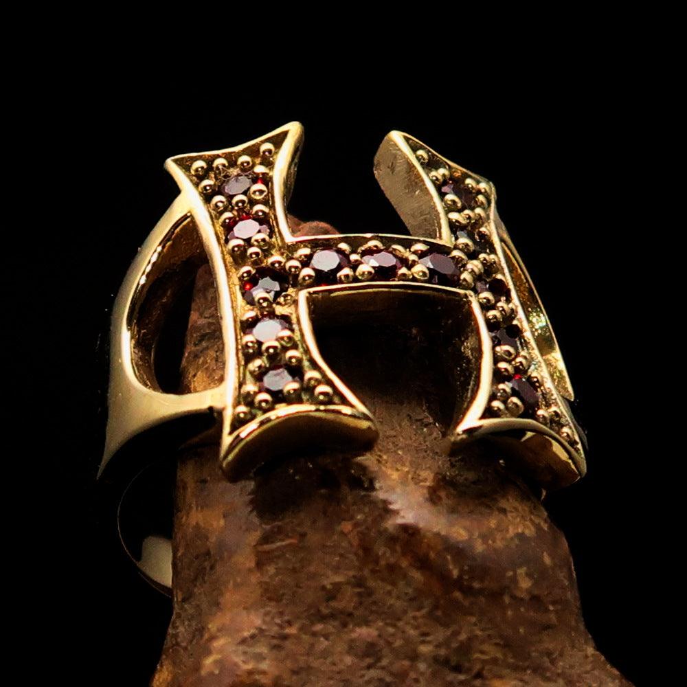 A beautifully crafted Initial Ring featuring a bold letter H, adorned with 13 red Cubic Zirconias, made from solid brass with a polished finish.