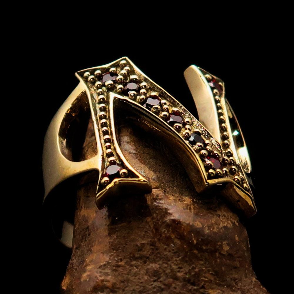 A beautifully crafted Initial Ring featuring a bold letter N, adorned with 8 red Cubic Zirconias, made from solid brass with a mirror polish finish.