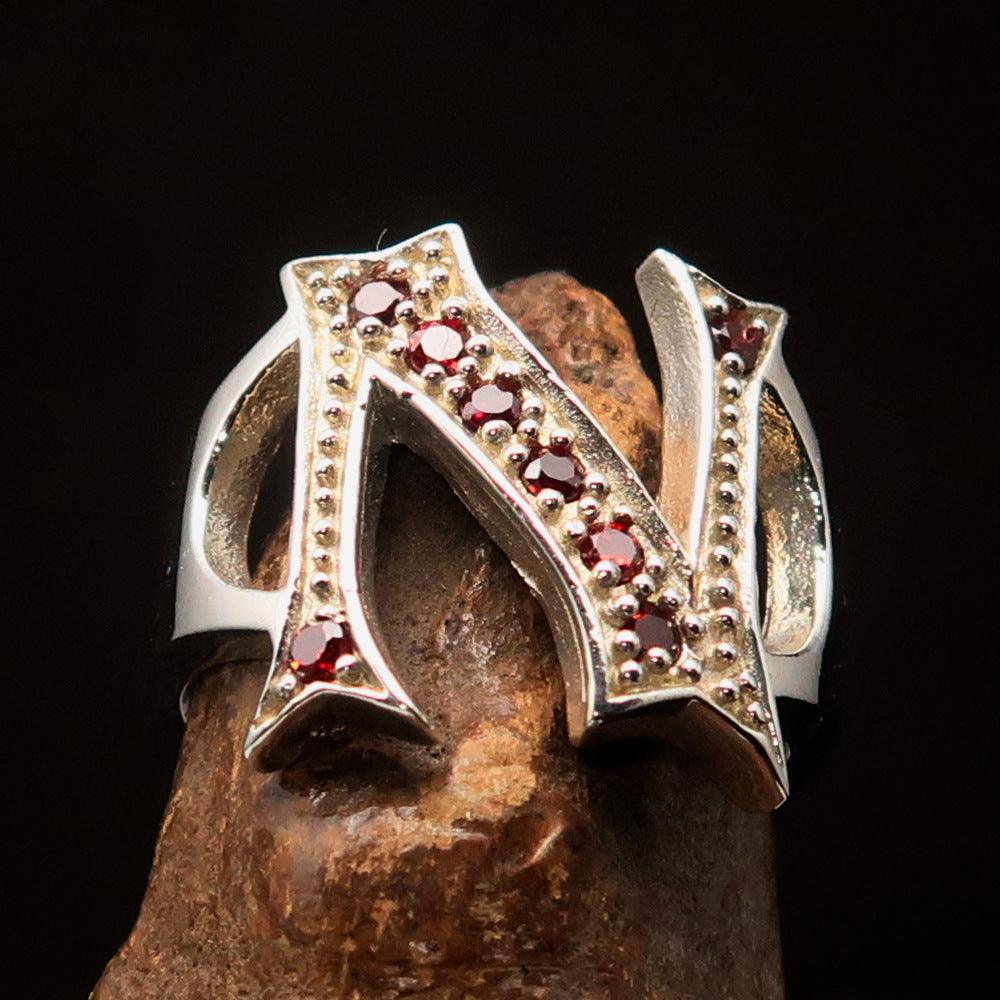 Excellent crafted Initial Ring featuring a bold letter N in sterling silver with 8 red Cubic Zirconias, showcasing a high-polished finish.