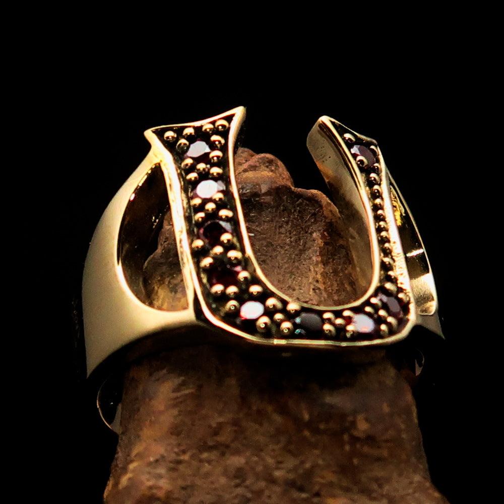 A beautifully crafted Initial Ring featuring a bold letter U, adorned with 9 red Cubic Zirconias, made from solid brass with a mirror polish finish.