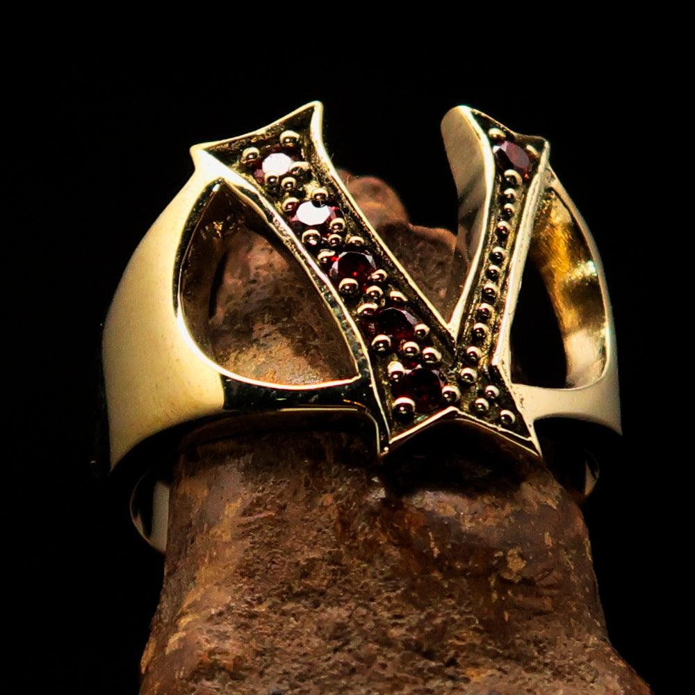 A beautifully crafted Initial Ring featuring a bold letter V, adorned with 6 red cubic zirconia stones, made from solid brass with a polished finish.