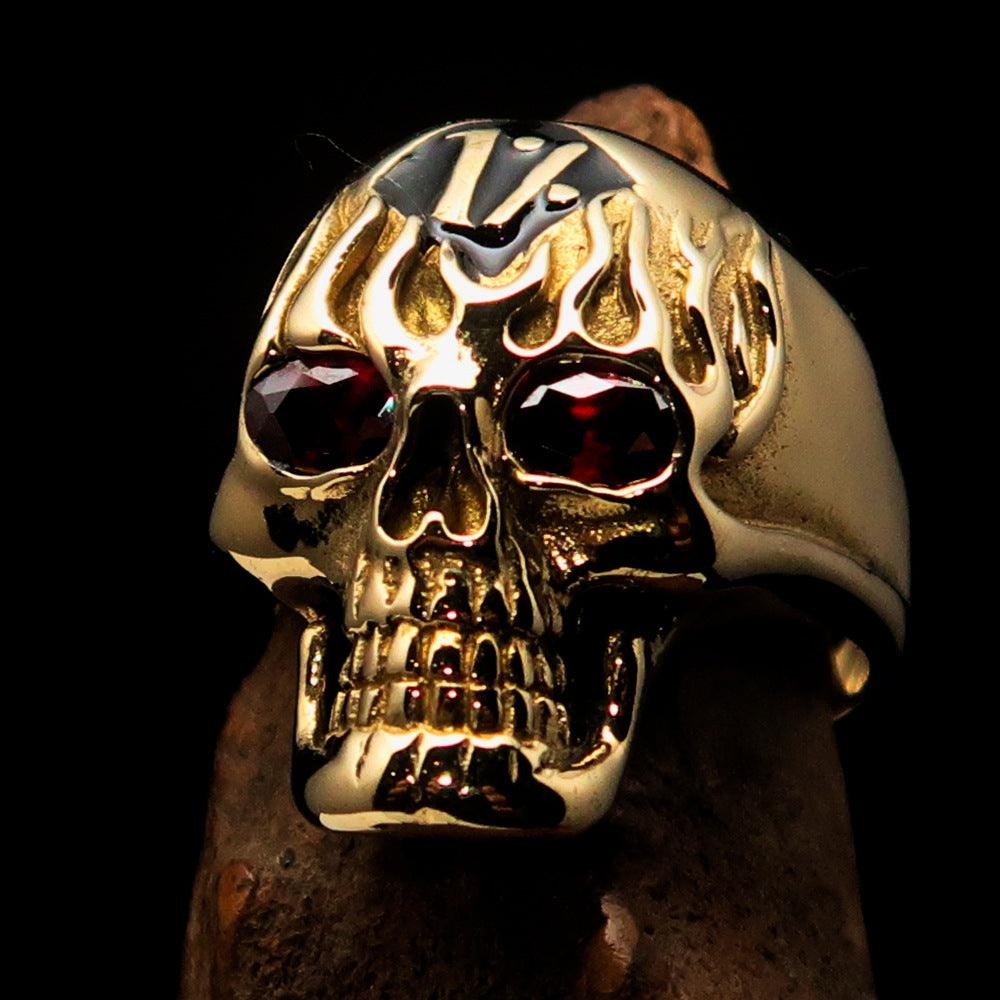 Men's black 1% Flaming Skull Outlaw Ring featuring red CZ eyes, crafted from solid brass with a polished finish.