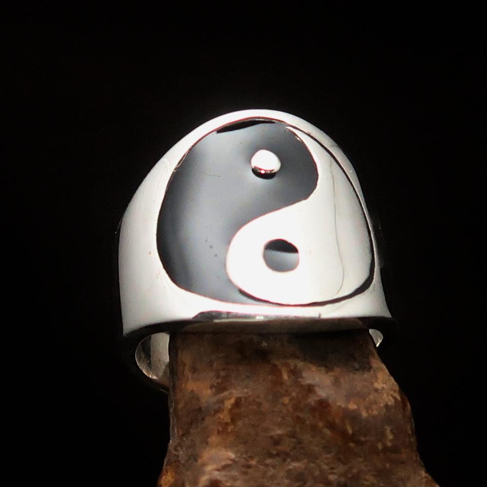 Men's black Yin Yang ring made of polished sterling silver with black enamel detailing, showcasing a unique design.