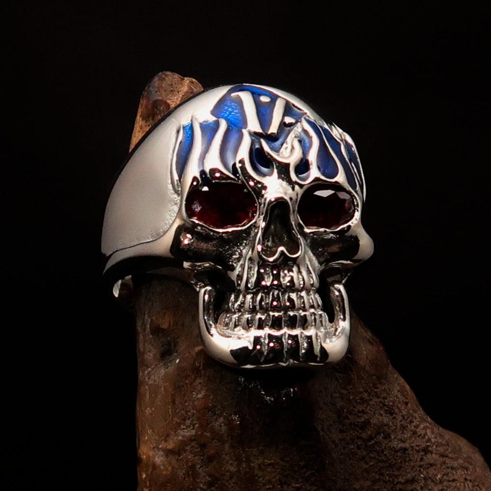 Men's blue 1% Flaming Skull Outlaw Ring featuring red cubic zirconia eyes, crafted from solid sterling silver with a polished finish.