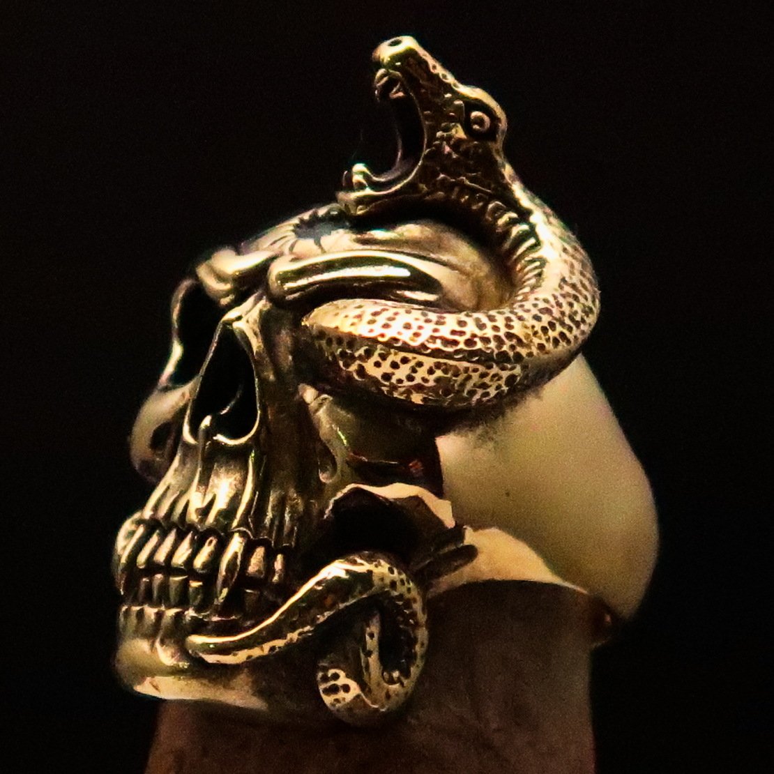 Men's Brass Biker Ring featuring a detailed skull and snake design, showcasing its rugged and stylish craftsmanship.